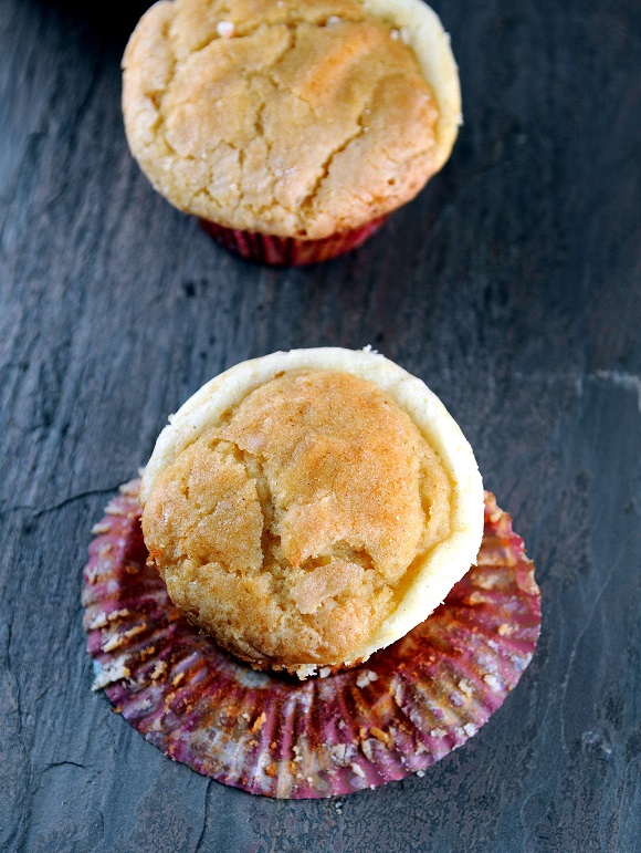 Overhead shot of Snickerdoodle Eggnog Cream Cheese Muffins with cupcake liner pulled back.