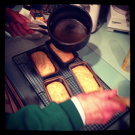 Pouring glaze over the mini loaves. 