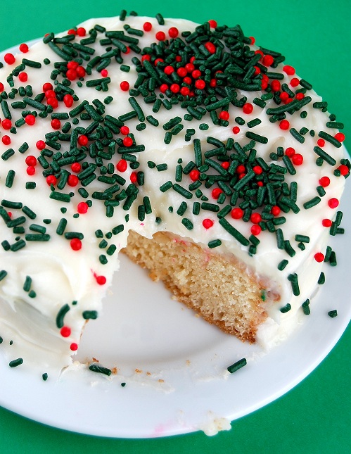 Overhead view of the Hot Eggnog Cake with a piece cut out of it.