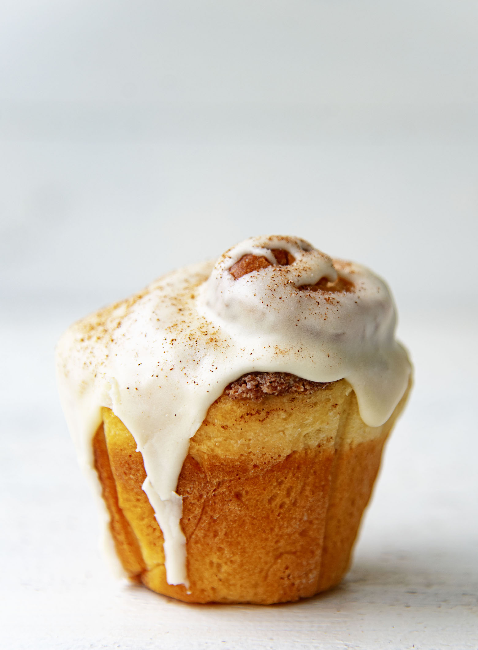 Single Bourbon Eggnog Breakfast Bun with glaze on it