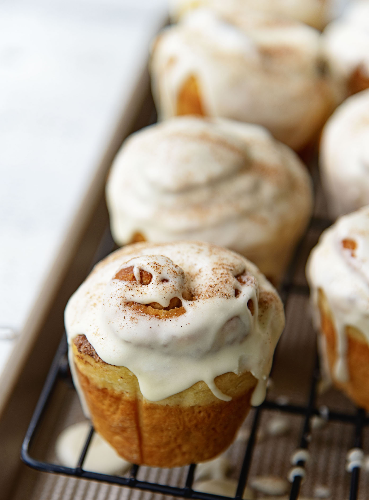 Row of Bourbon Eggnog Breakfast Buns on a wire rack