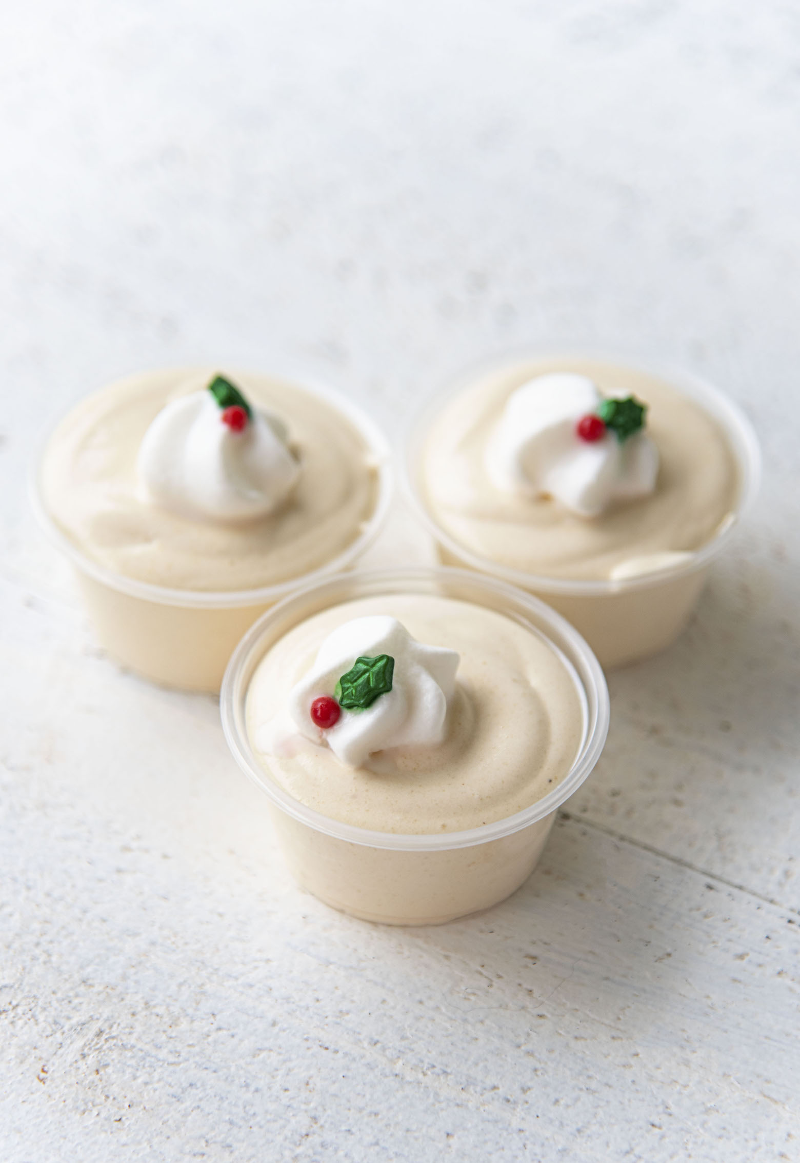 Three Bourbon Eggnog Pudding Shots clustered together.