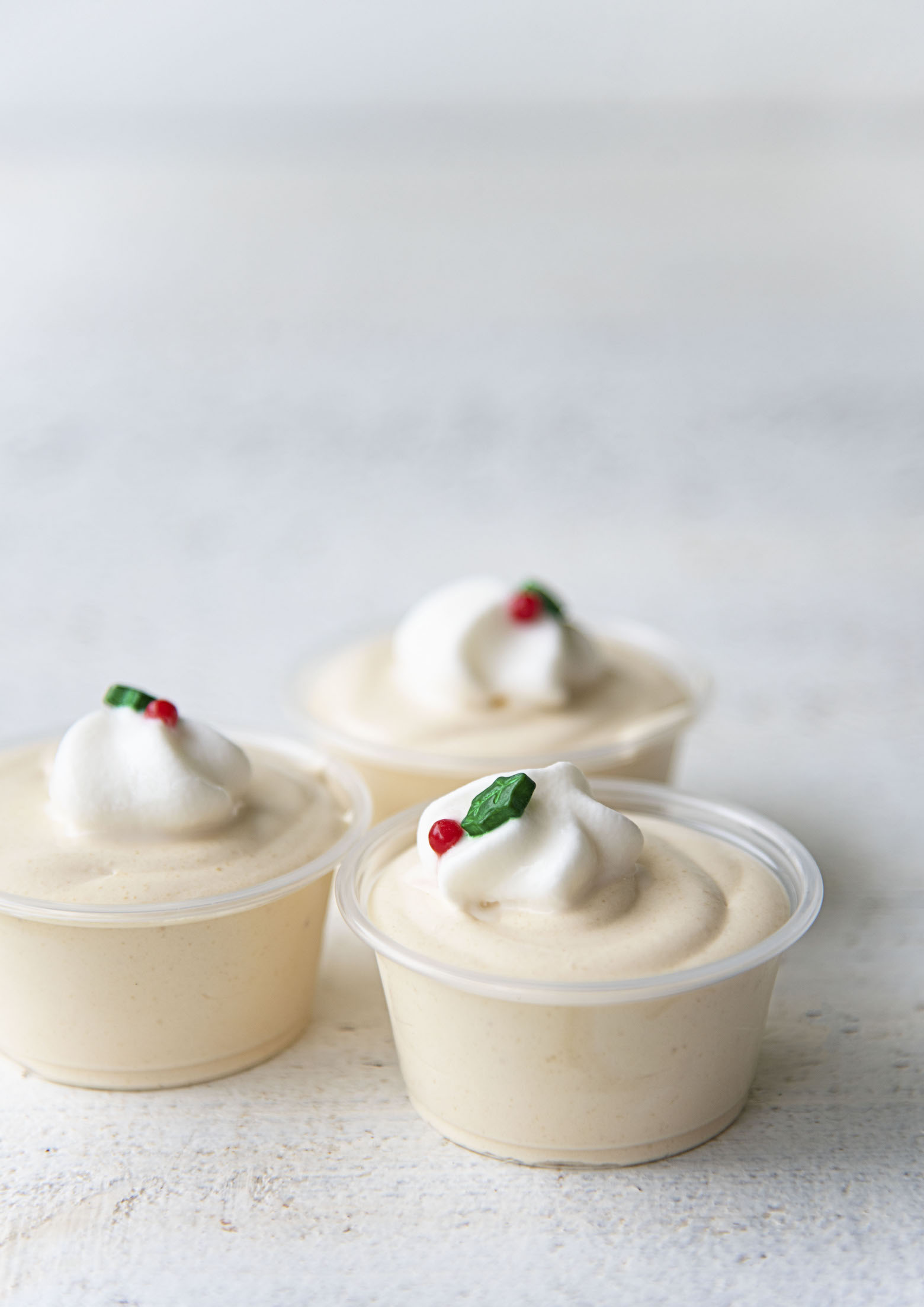 Side view of three Bourbon Eggnog Pudding Shots. 