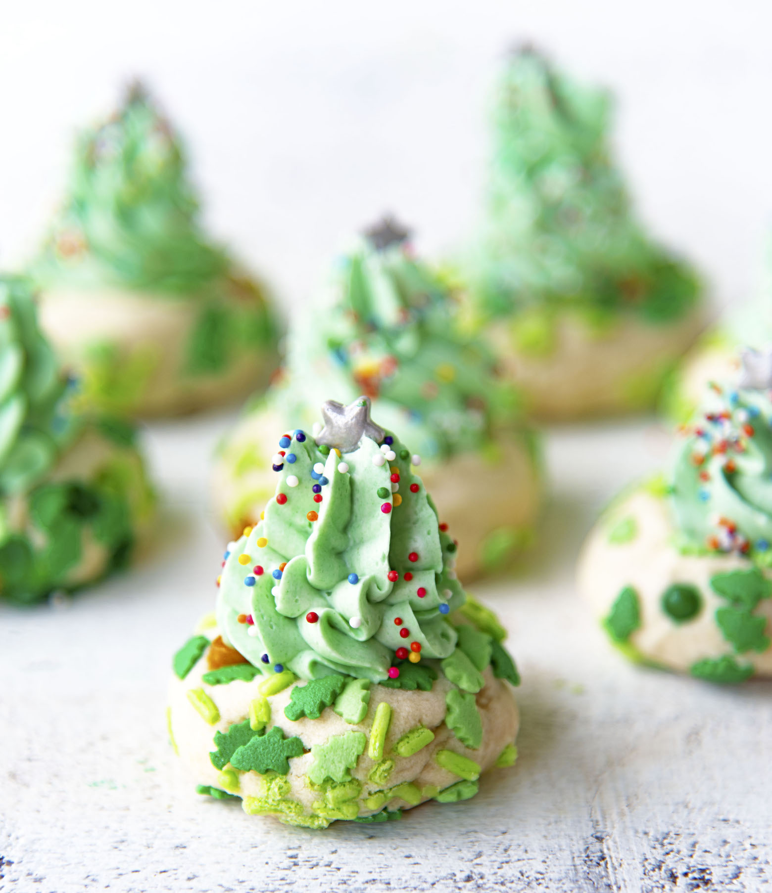 Gathering of several Christmas Tree Thumbprint Cookies. 