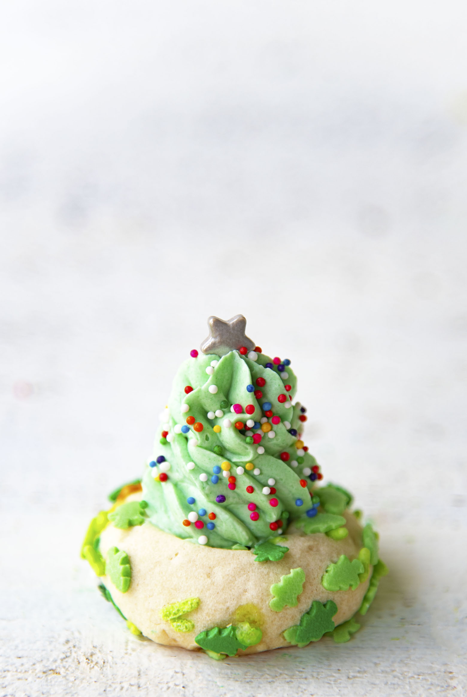 Single thumbprint cookie with buttercream frosting tree.