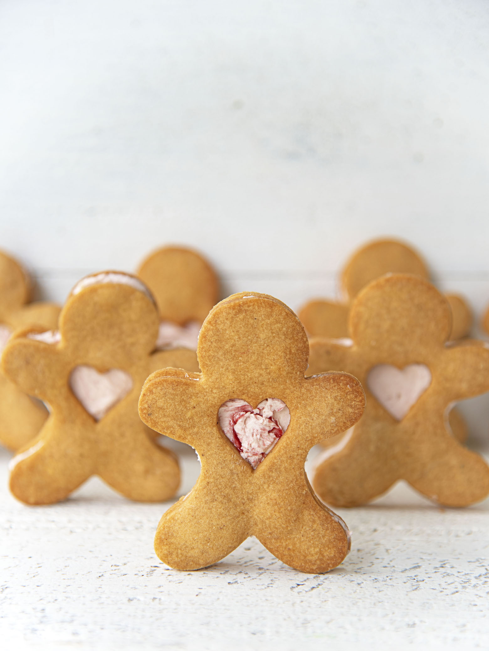 Rows of Gingerbread Shortbread Sandwich Cookies standing up.