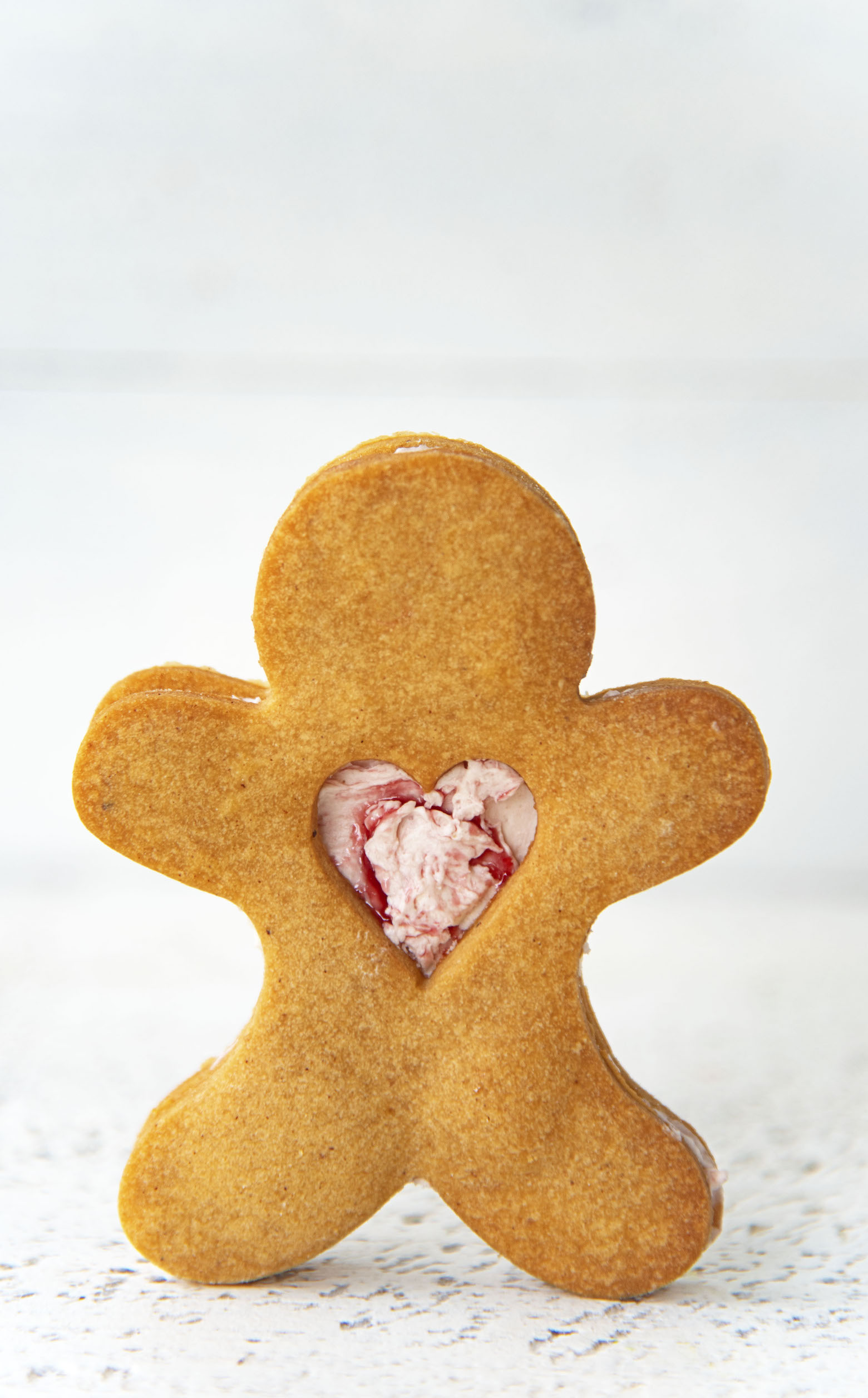 Shot of a single Gingerbread Shortbread Sandwich Cookie standing up.