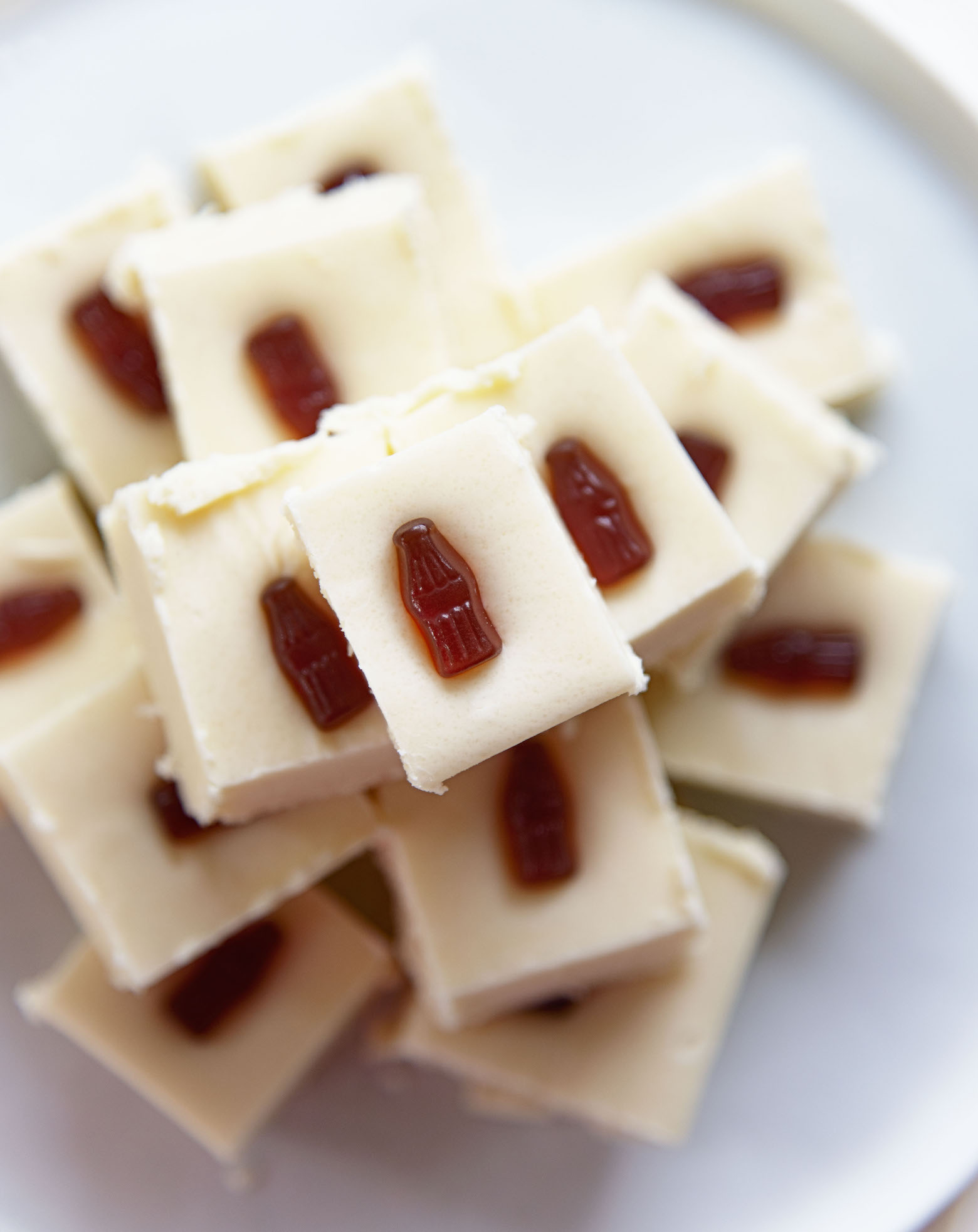 Overhead shot of plate of fudge with focus on the top piece of fudge. 