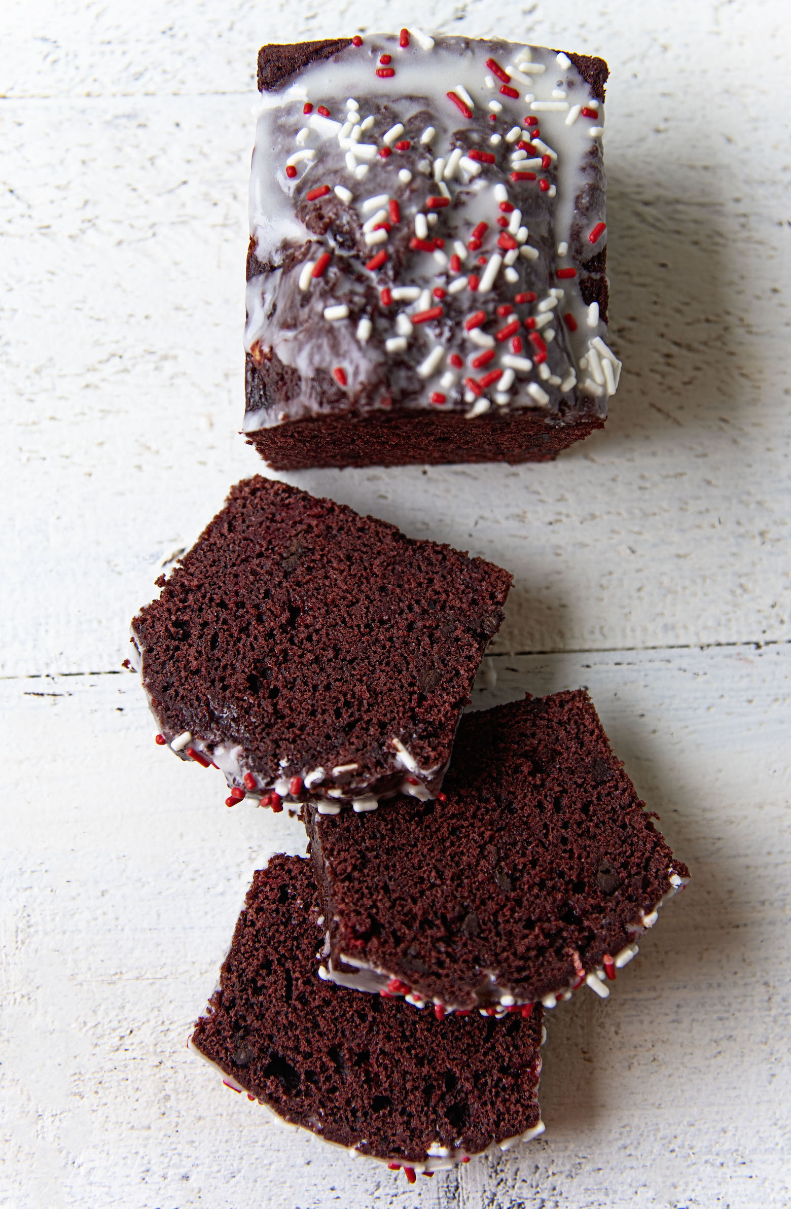 Overhead shot of Peppermint Red Velvet Loaf Cake cut with the slices laid out. 