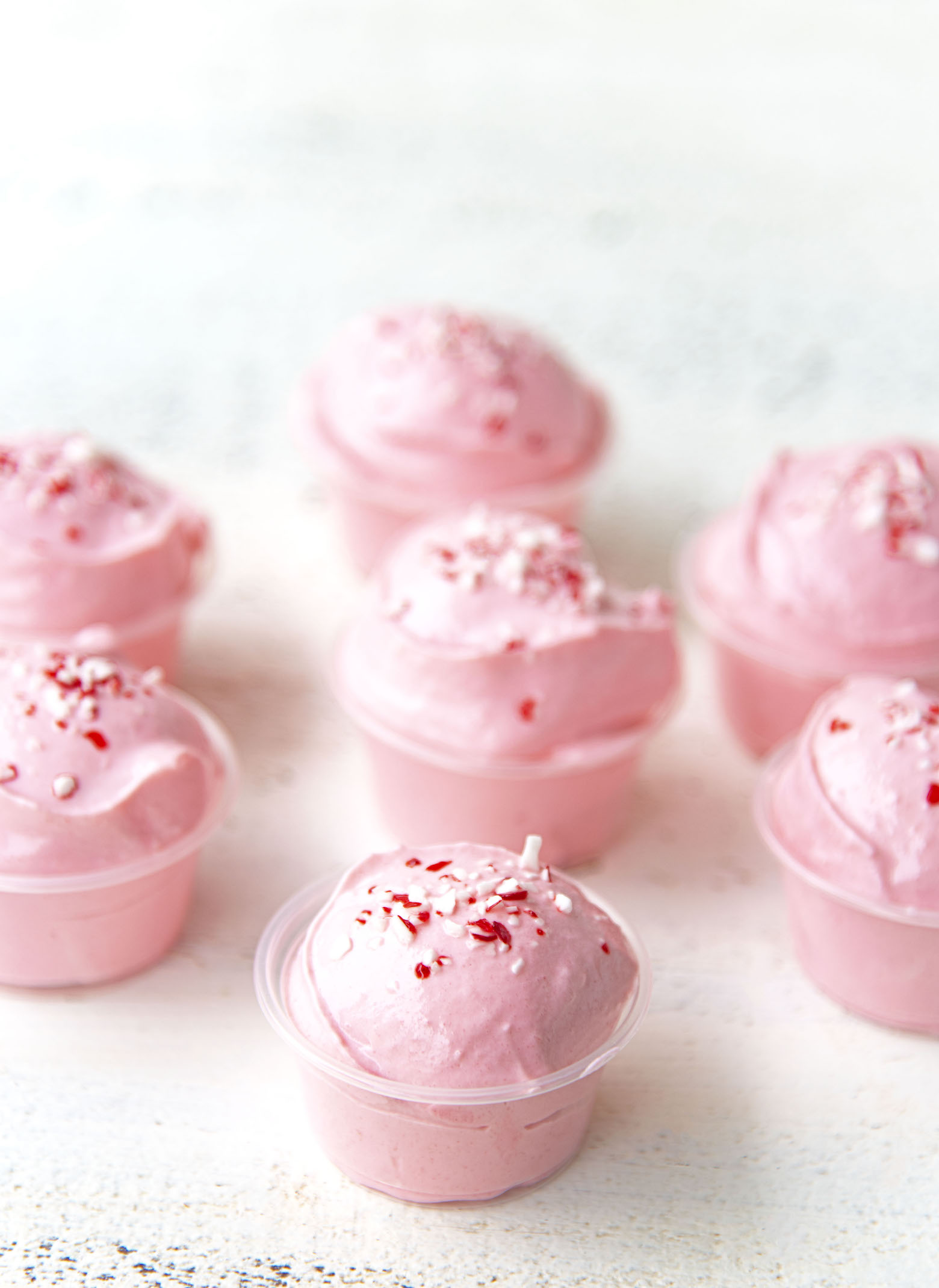 A bunch of Peppermint White Chocolate Pudding Shots together. 