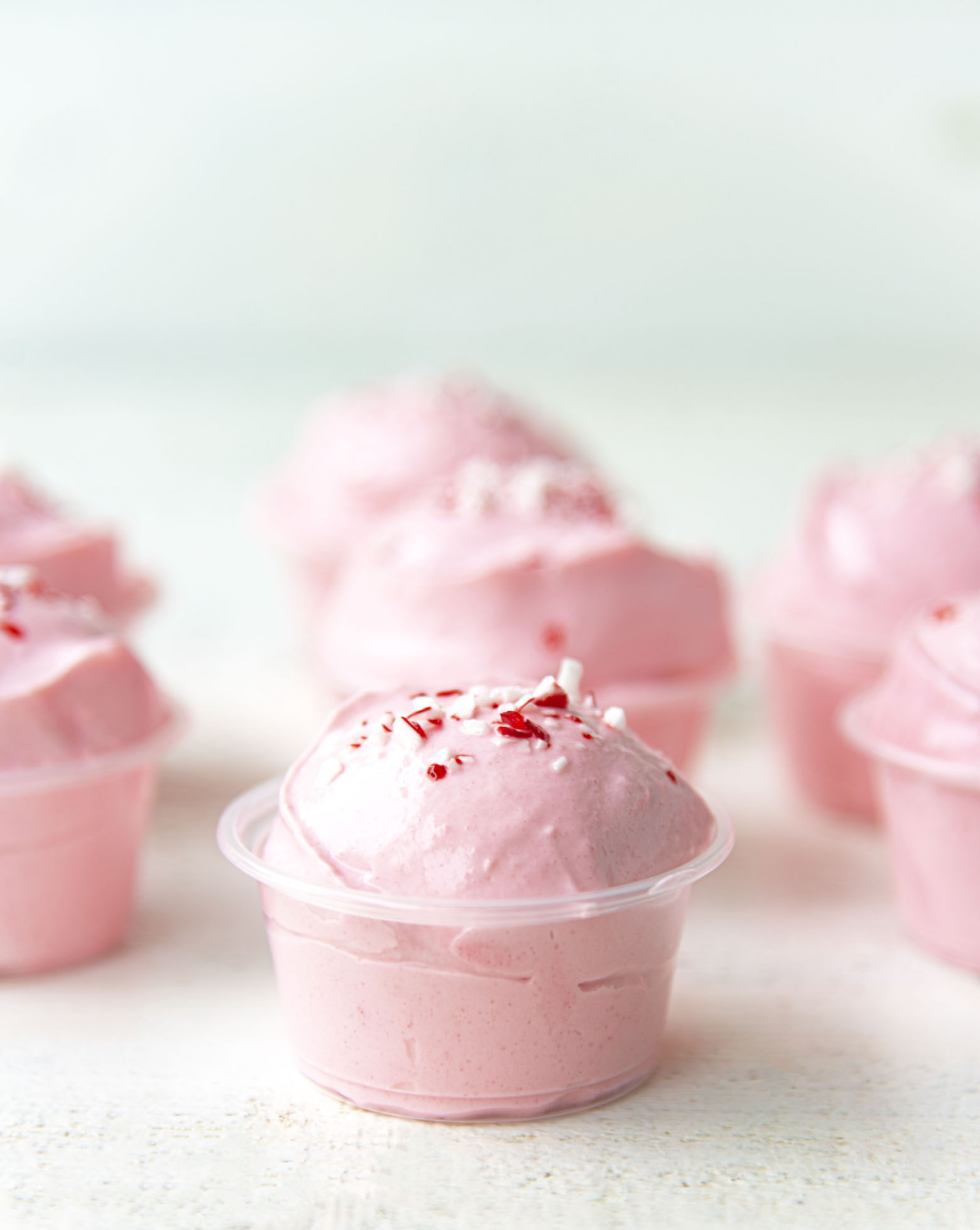 Side view of Peppermint White Chocolate Pudding Shots with focus on the first shot.