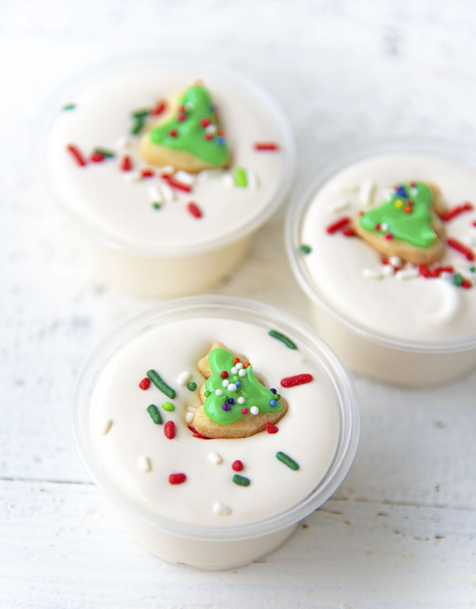 Three Sugar Cookie Pudding Shots with mini cookies on them. 