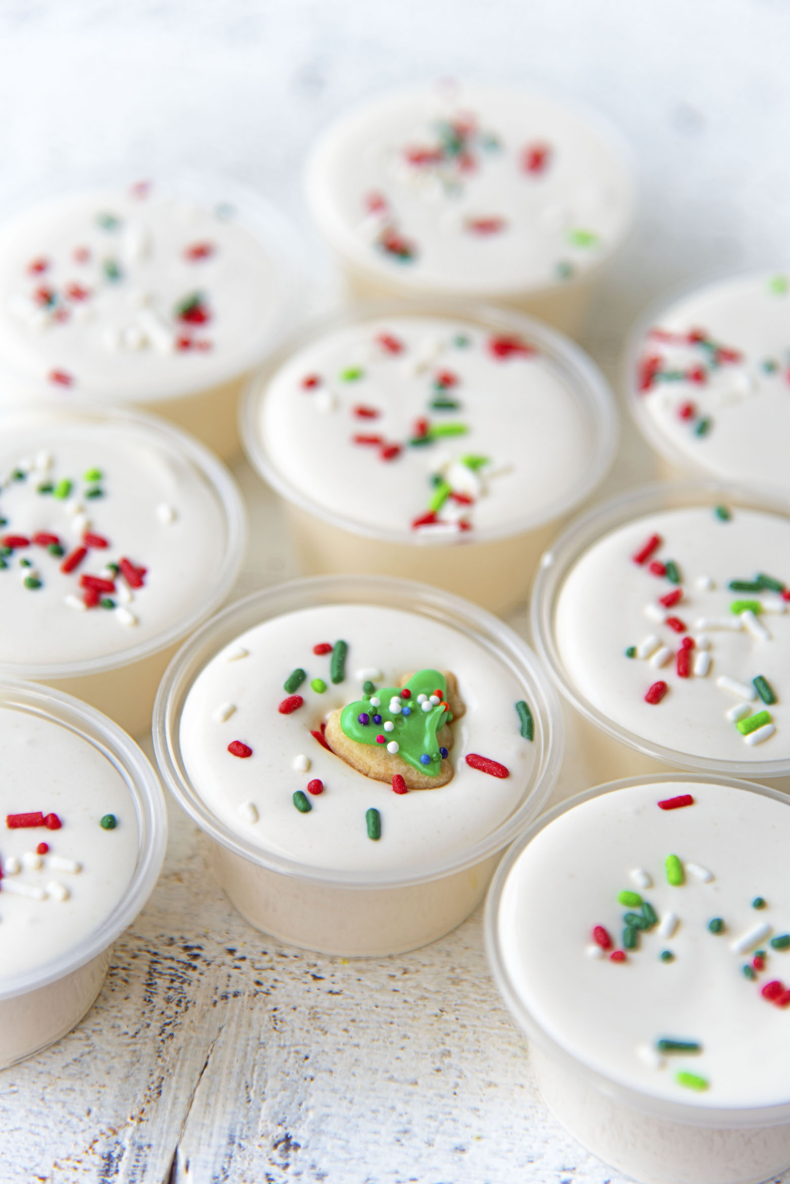 Cluster of pudding shots with focus on the one with the cookie on it. 