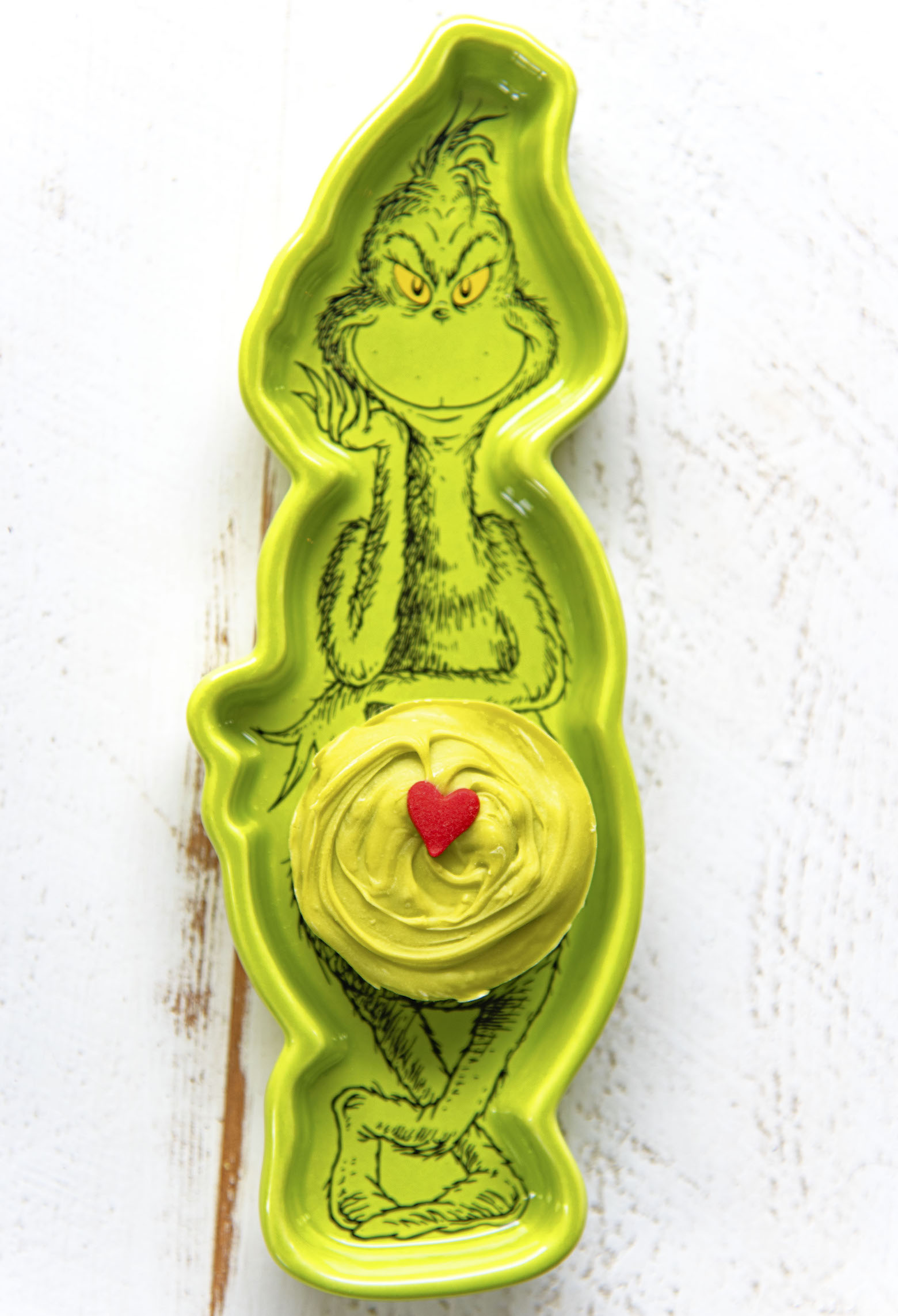 Overhead shot of single sugar cookie cup in the Grinch dish.