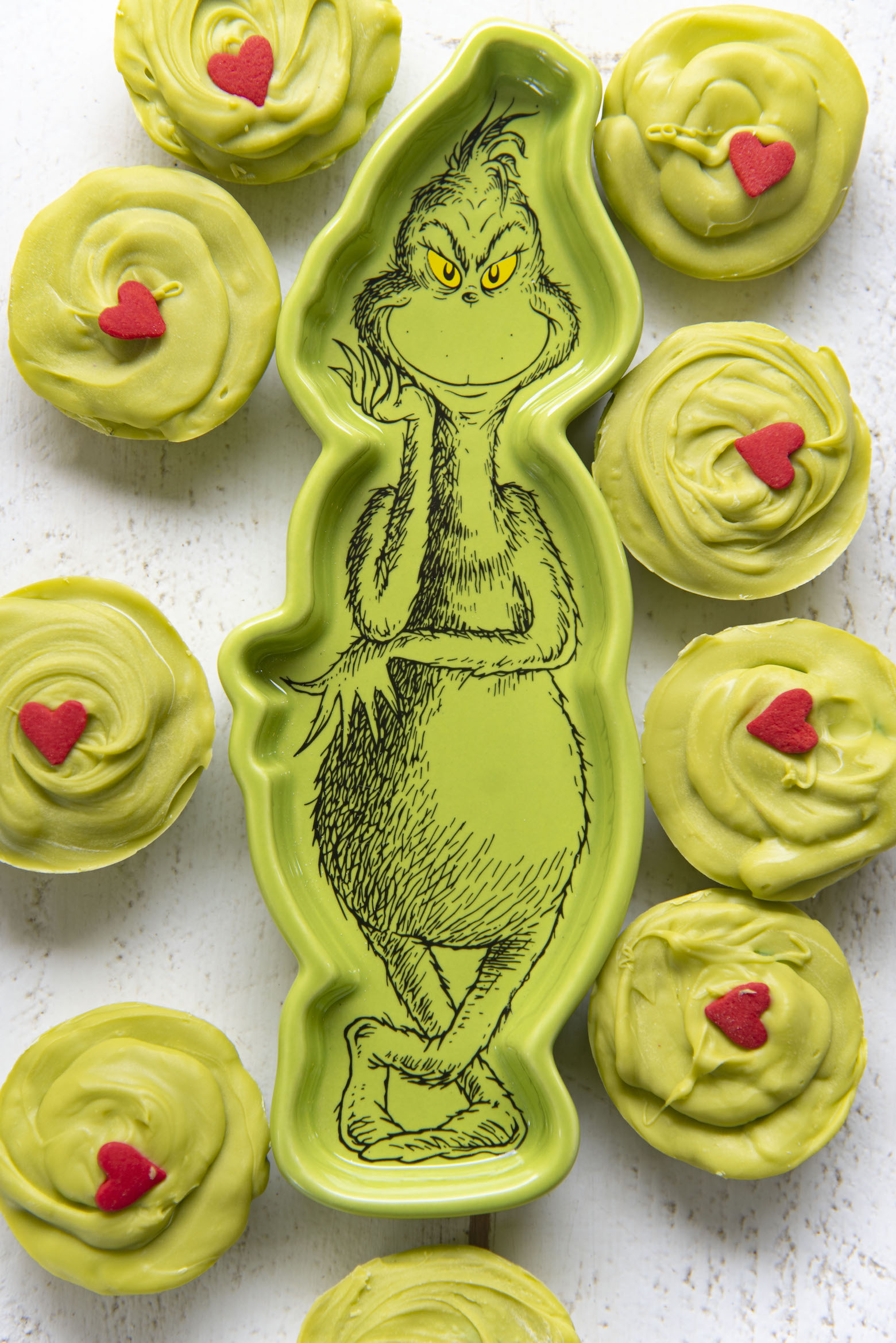 Overhead shot of The Grinch Sugar Cookie Cups surrounding a Grinch dish. 