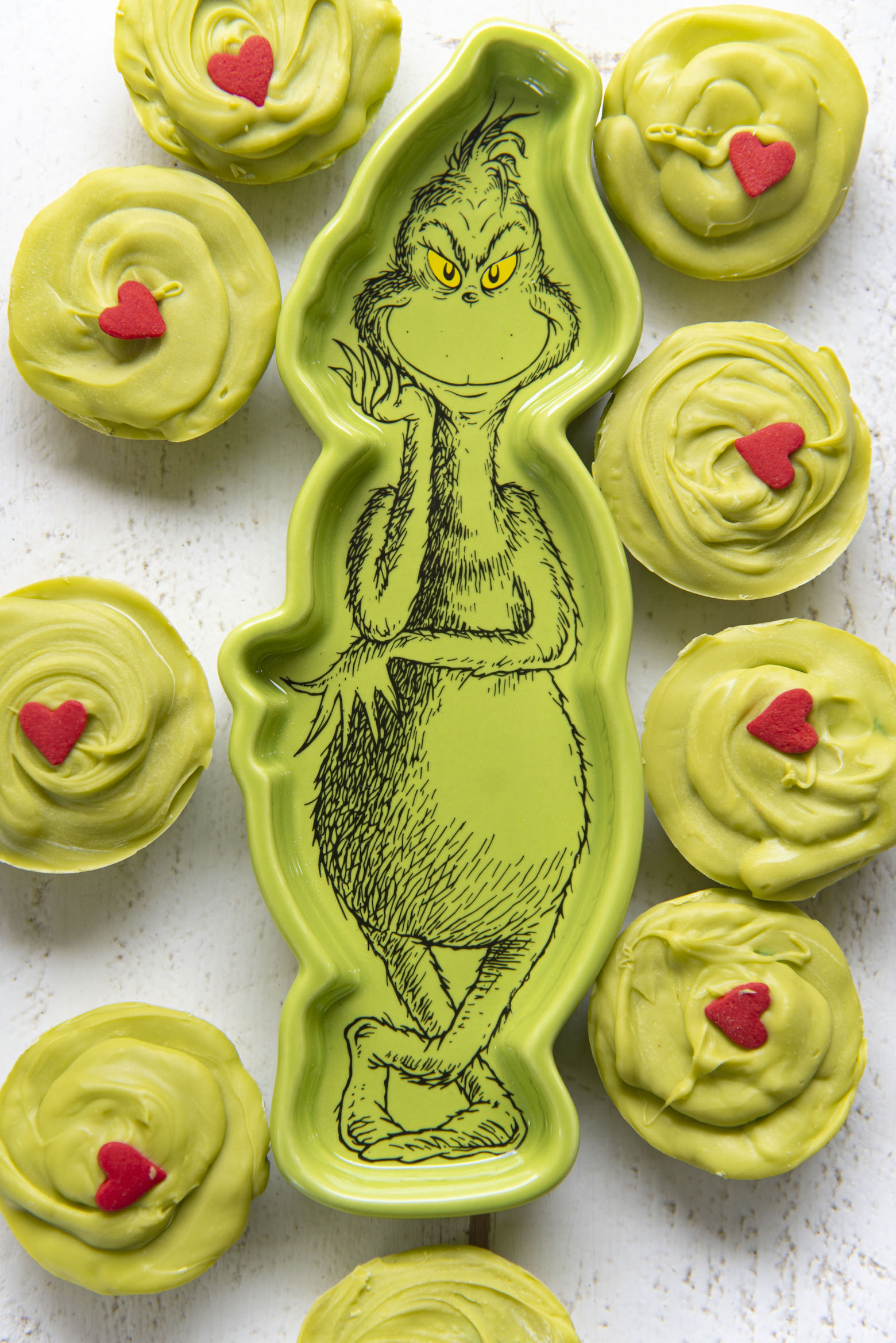 Overhead shot of The Grinch Sugar Cookie Cups surrounding a Grinch dish.