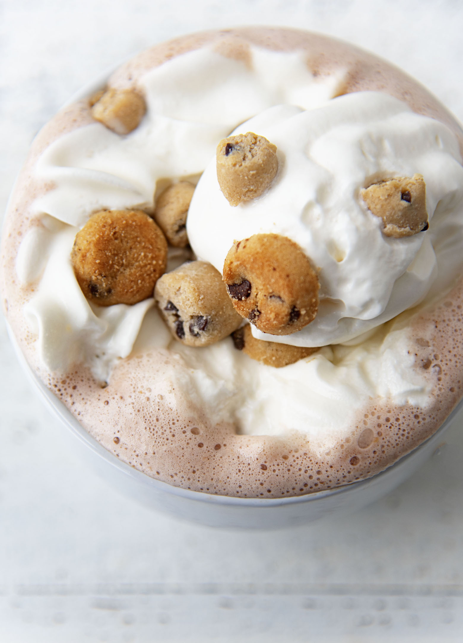 Close up of the whipped cream, cookie dough pieces, and mini chocolate chip cookies.