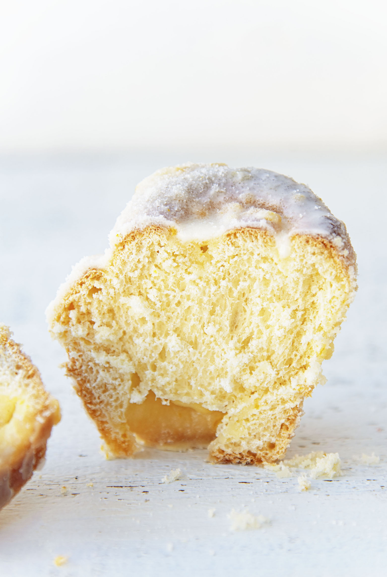 Slice of a single Mimosa Sugared Sweet Roll standing upright cut open.
