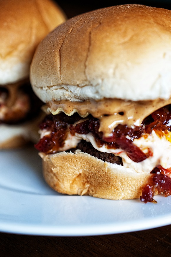 Two Peanut Butter Bourbon Bacon Jam Pimento Cheese Potato Chip Sliders with the first slider close up. 