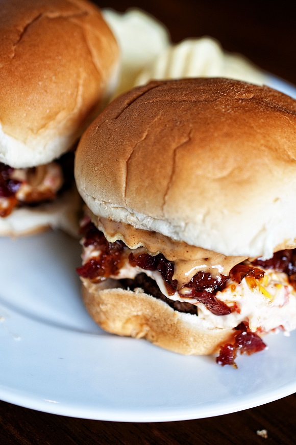 Two Peanut Butter Bourbon Bacon Jam Pimento Cheese Potato Chip Sliders on a plate with potato chips. 