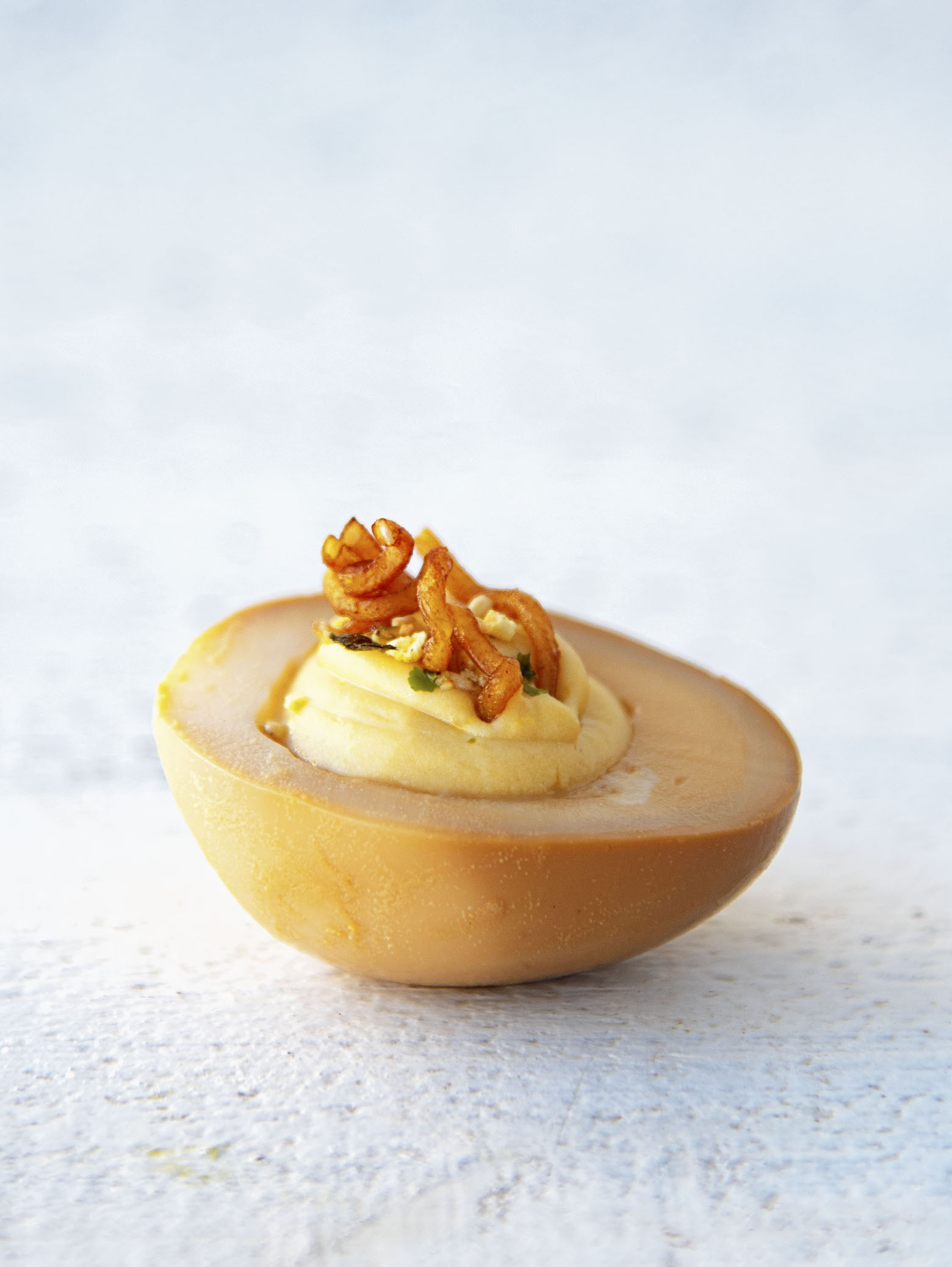 Side view of a single Soy Sauce Ramen Deviled Egg
