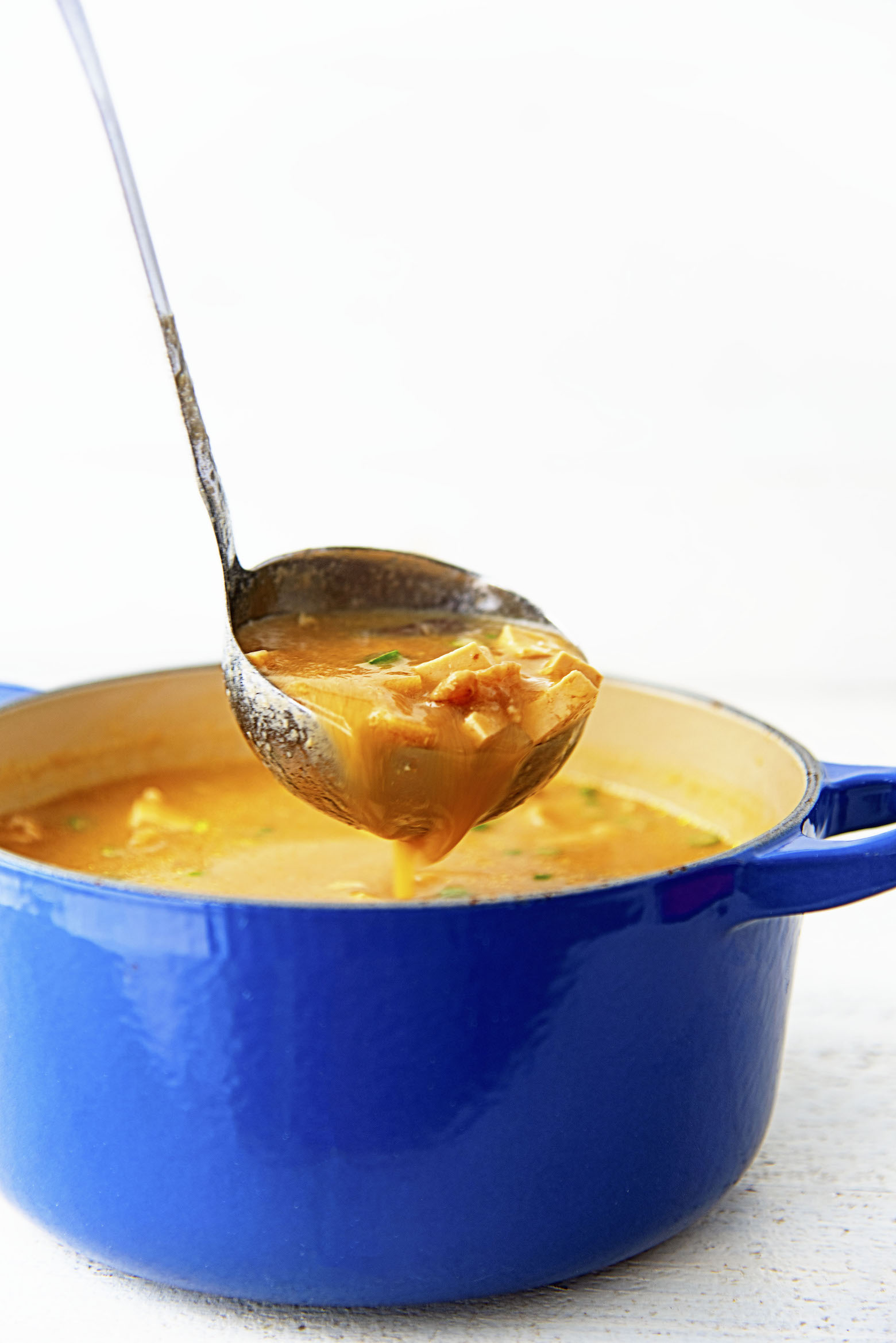 Soup being saddled up out of the soup pot.