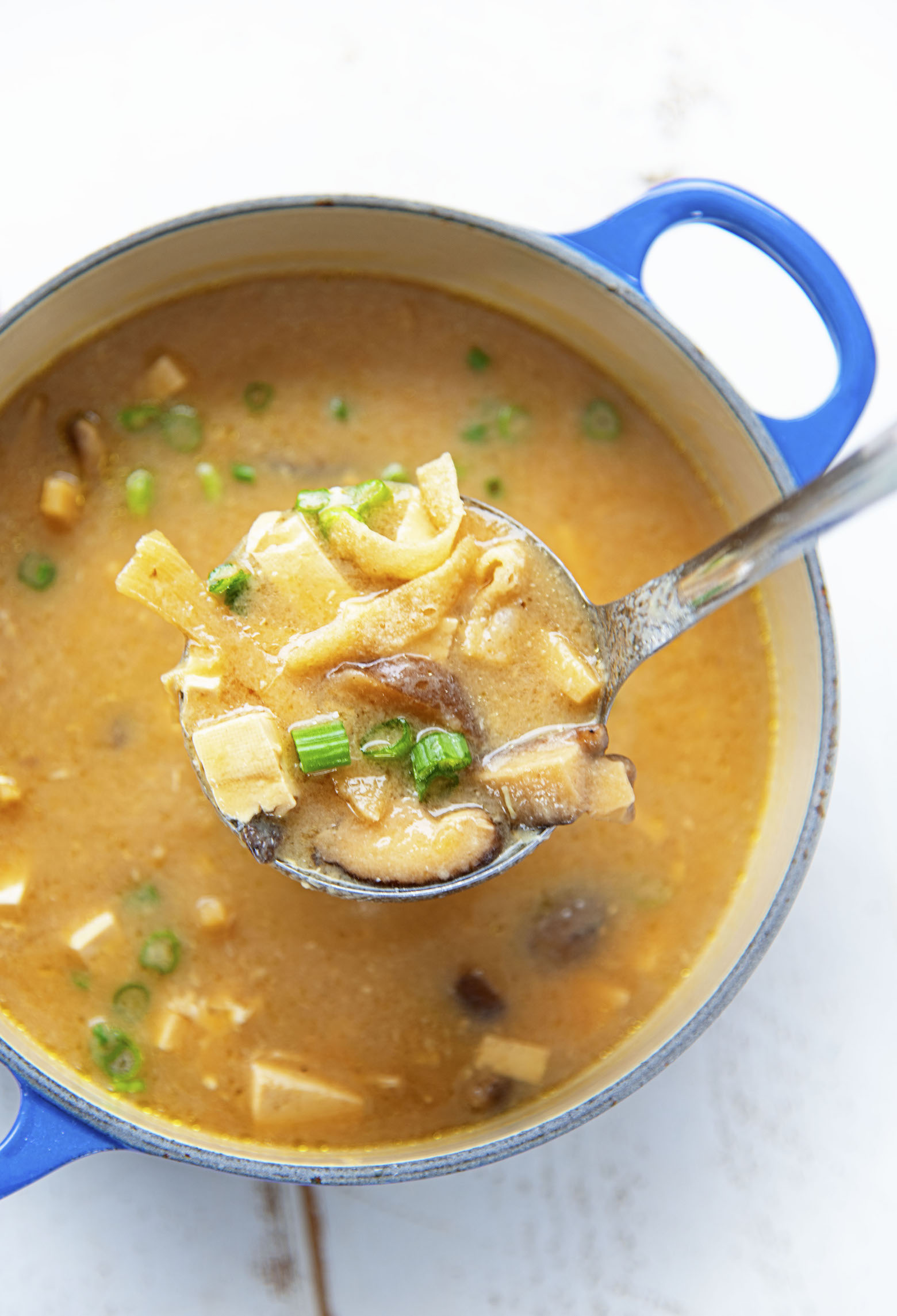 Close up of a shot of the ladle with soup in it. 