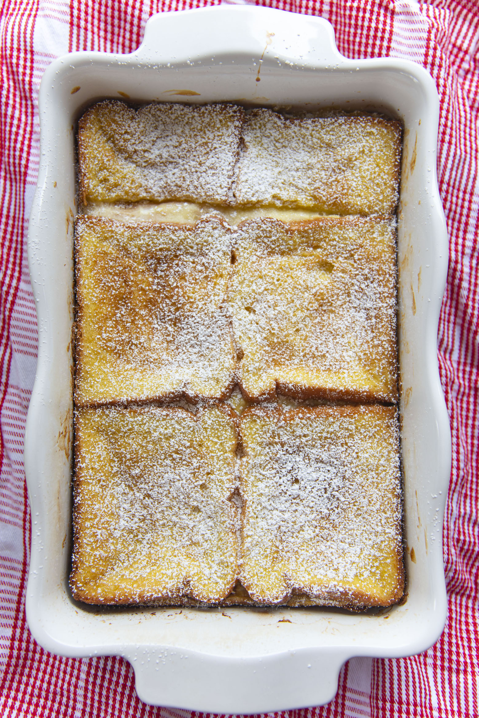 Overhead shot Vegetarian Monte Cristo Casserole dusted with powdered sugar. 