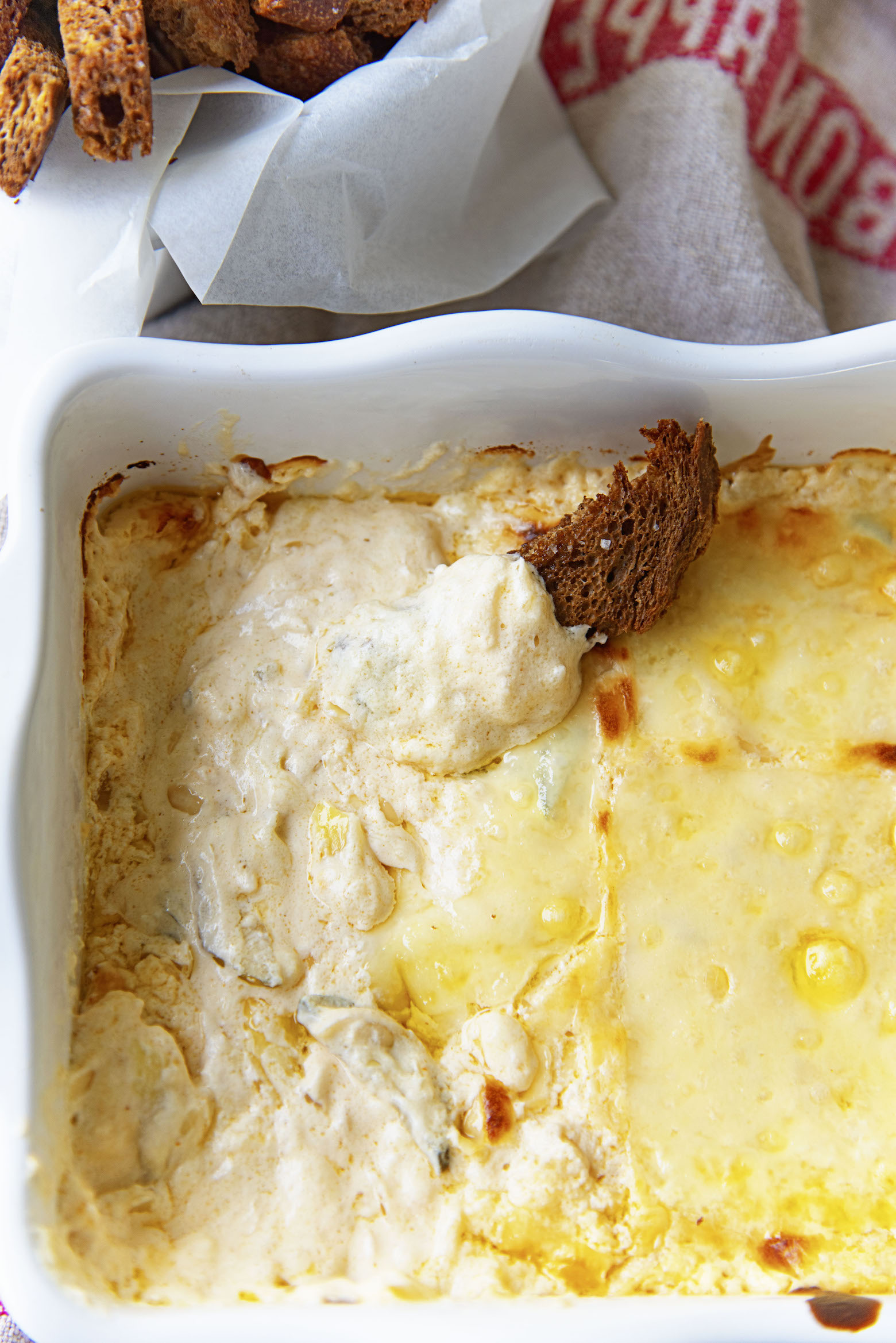 Overhead shot of the dip with a rye bread crouton in it. 