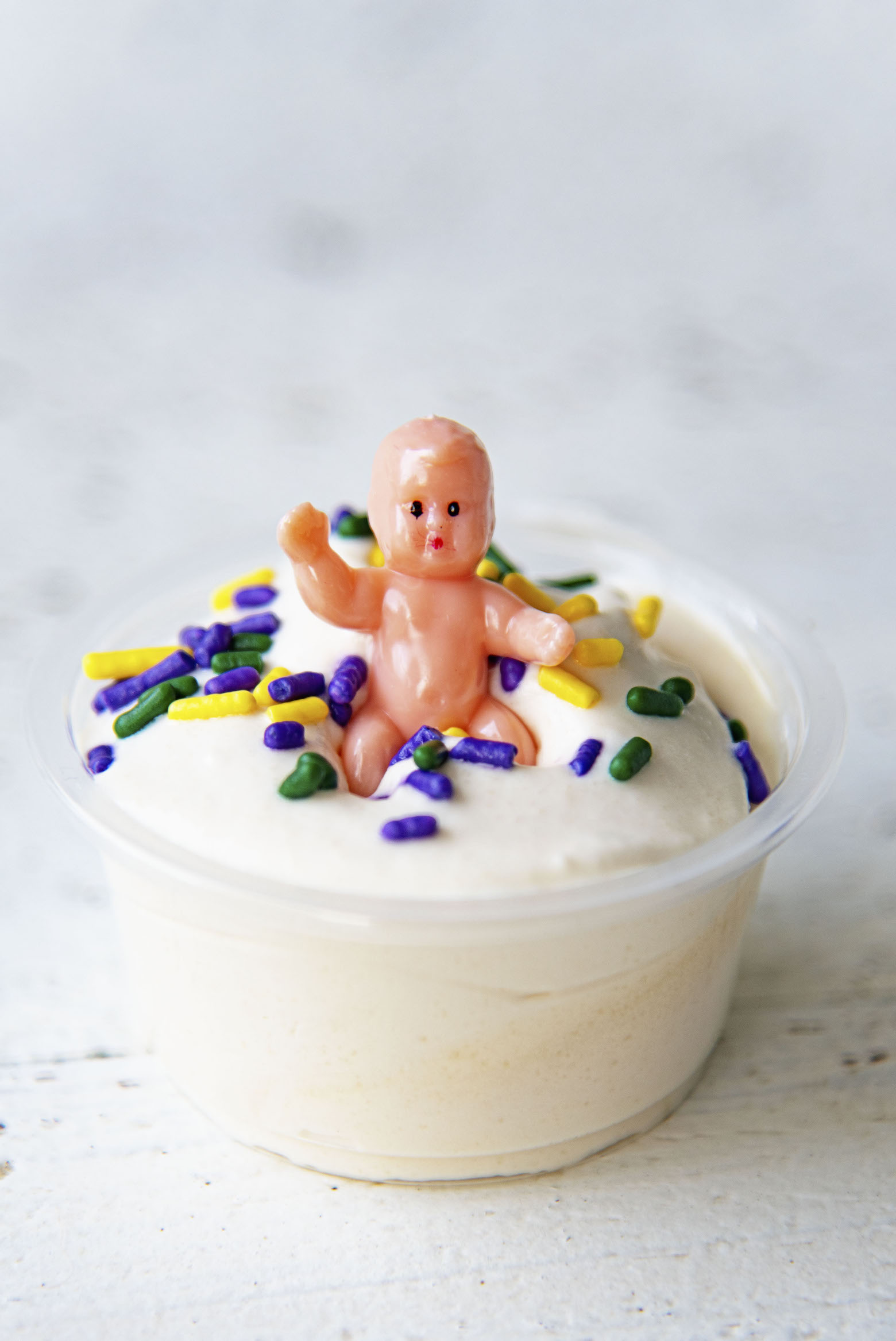 Close up of single King Cake Pudding Shot with the baby on top.