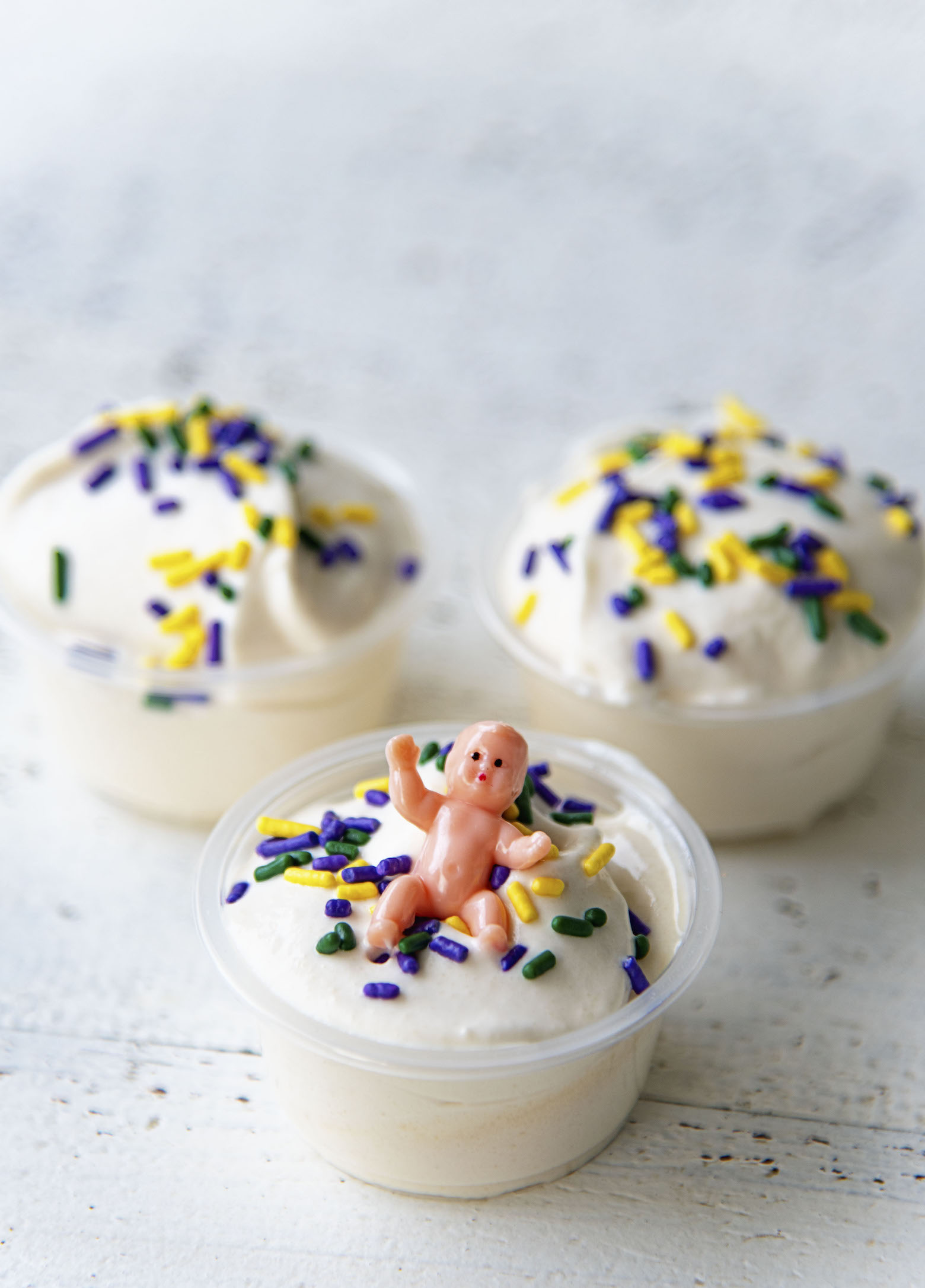 Three King Cake Pudding Shots together with the one with the baby up front.