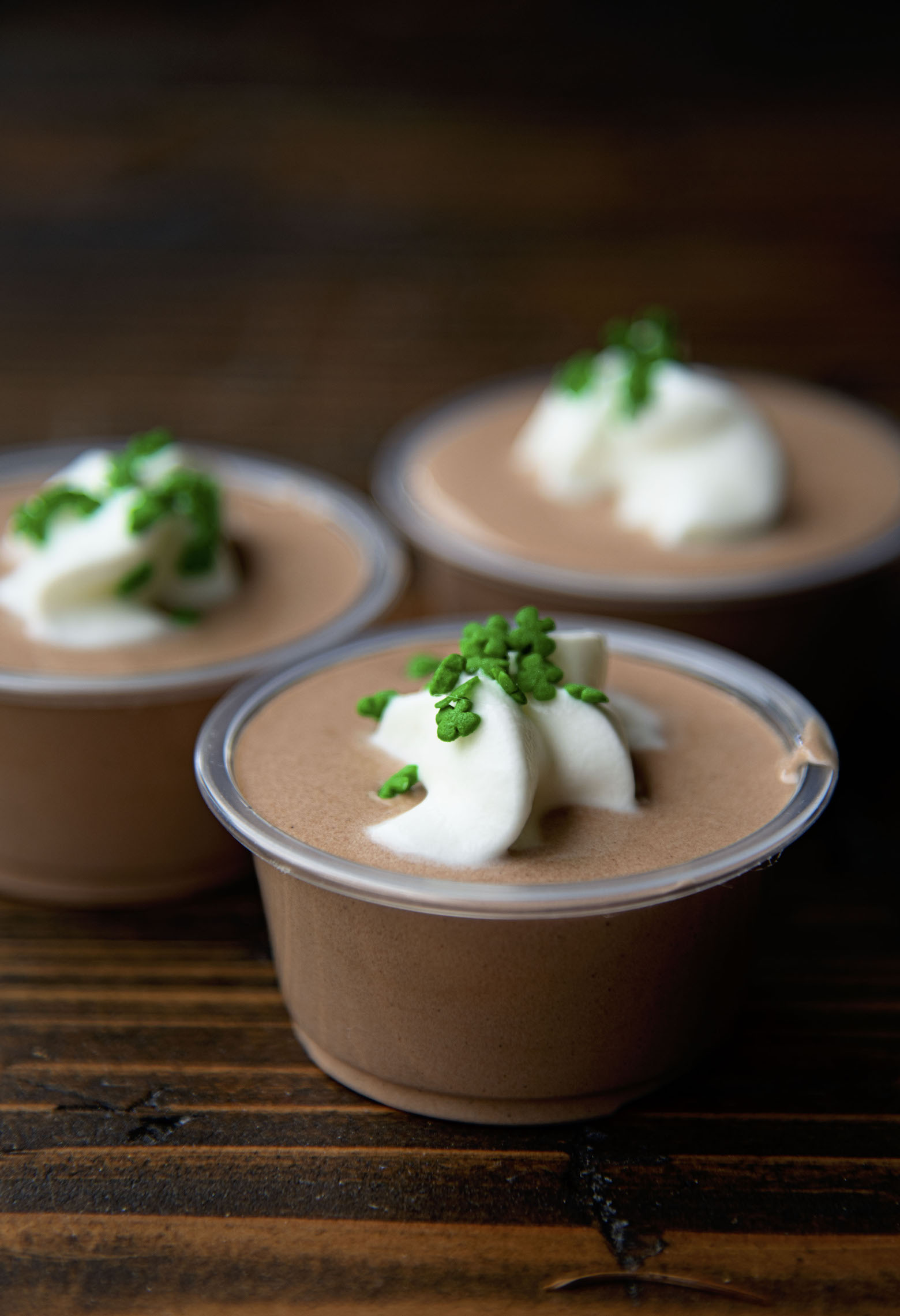 Three Irish Coffee Pudding Shots with focus on the first shot.