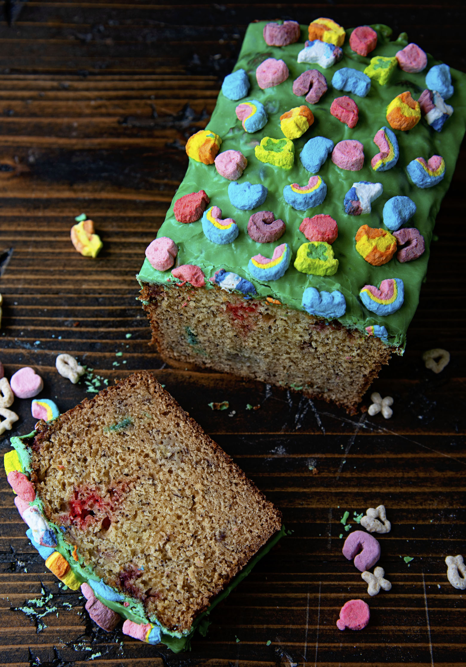 Overhead view of Lucky Charms Banana Bread with one slice out in front. 