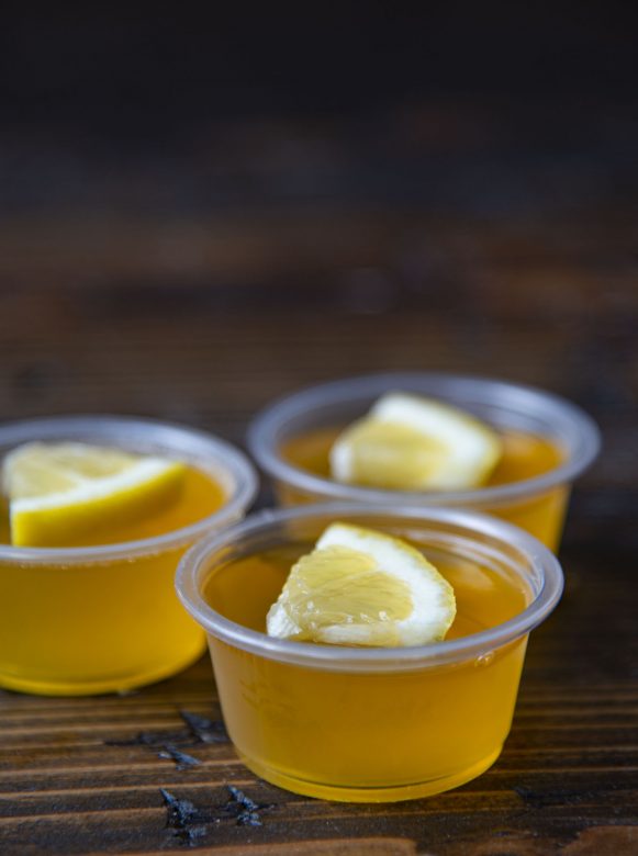 Side view of three Lynchburg Lemonade Jello Shots with focus on the first shot