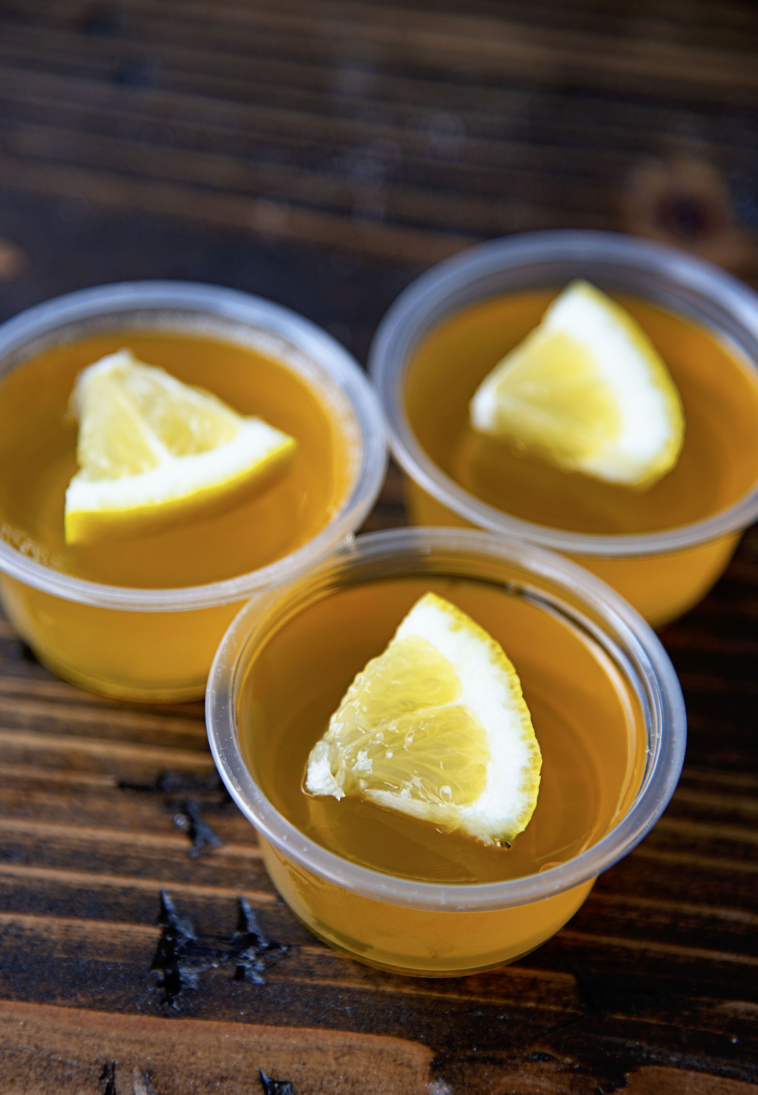 Three quarter shot of three Lynchburg Lemonade Jello Shots grouped together with the focus on the first shot.