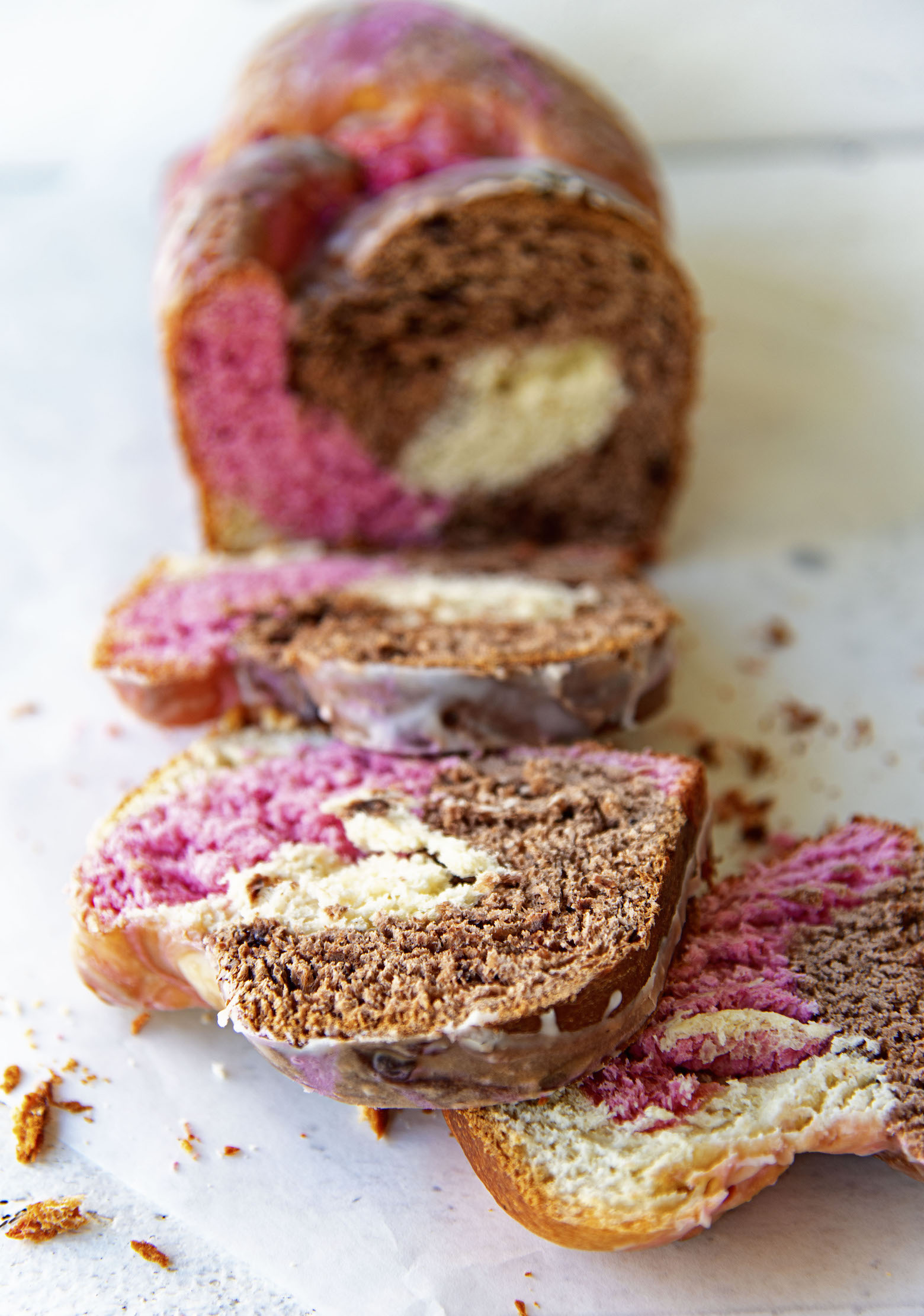 Shot of the Neapolitan Ice Cream Babka sliced up with pieces fallen down.