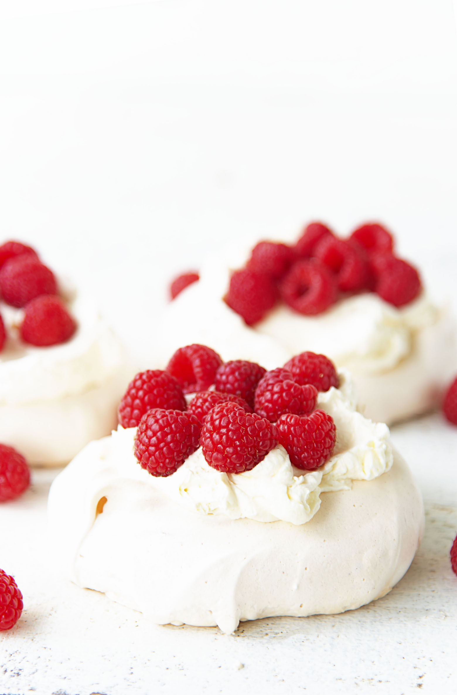 Side view of three Raspberry Lemon Elderflower Pavlovas