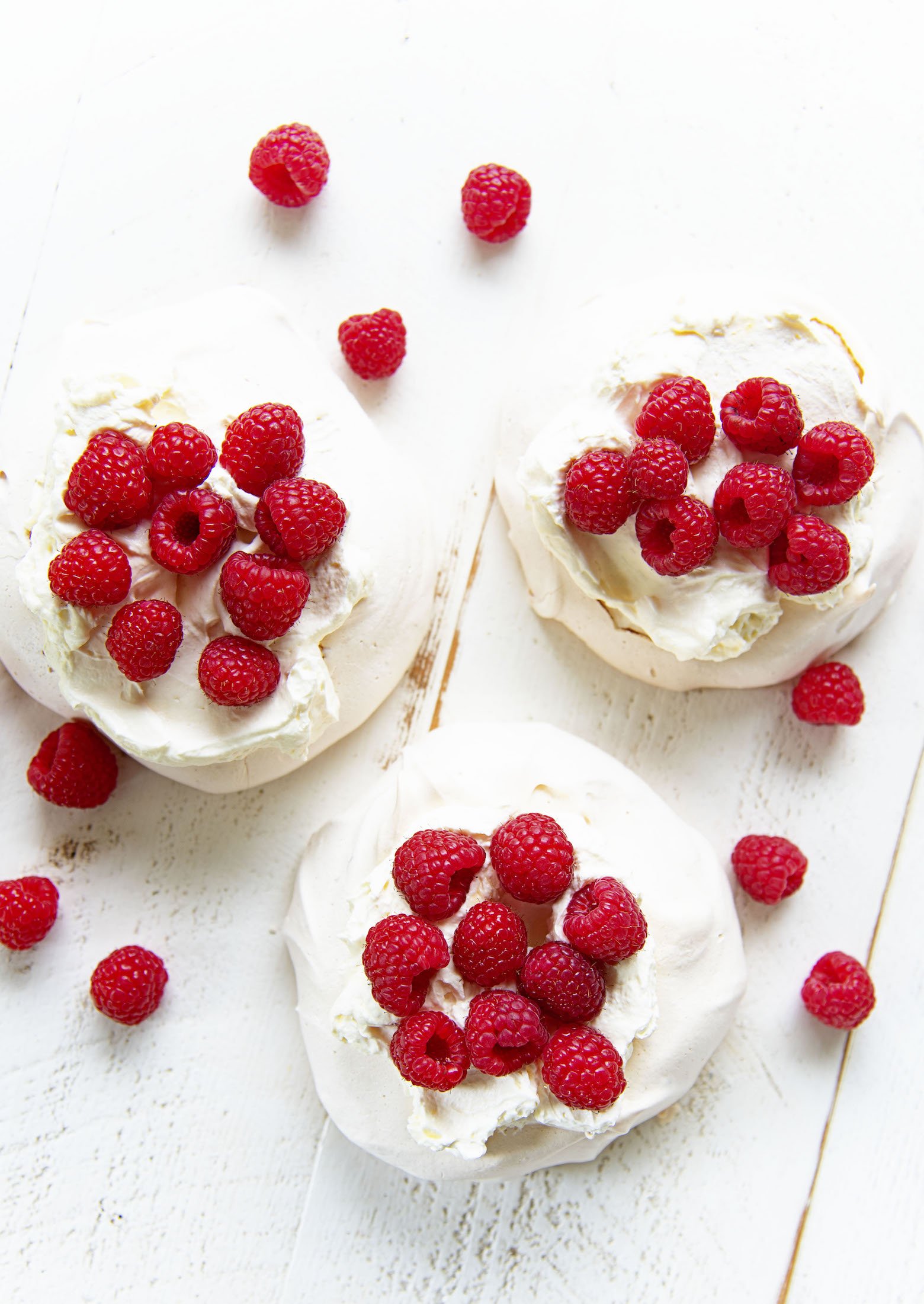Overhead shot of three Raspberry Lemon Elderflower Pavlovas