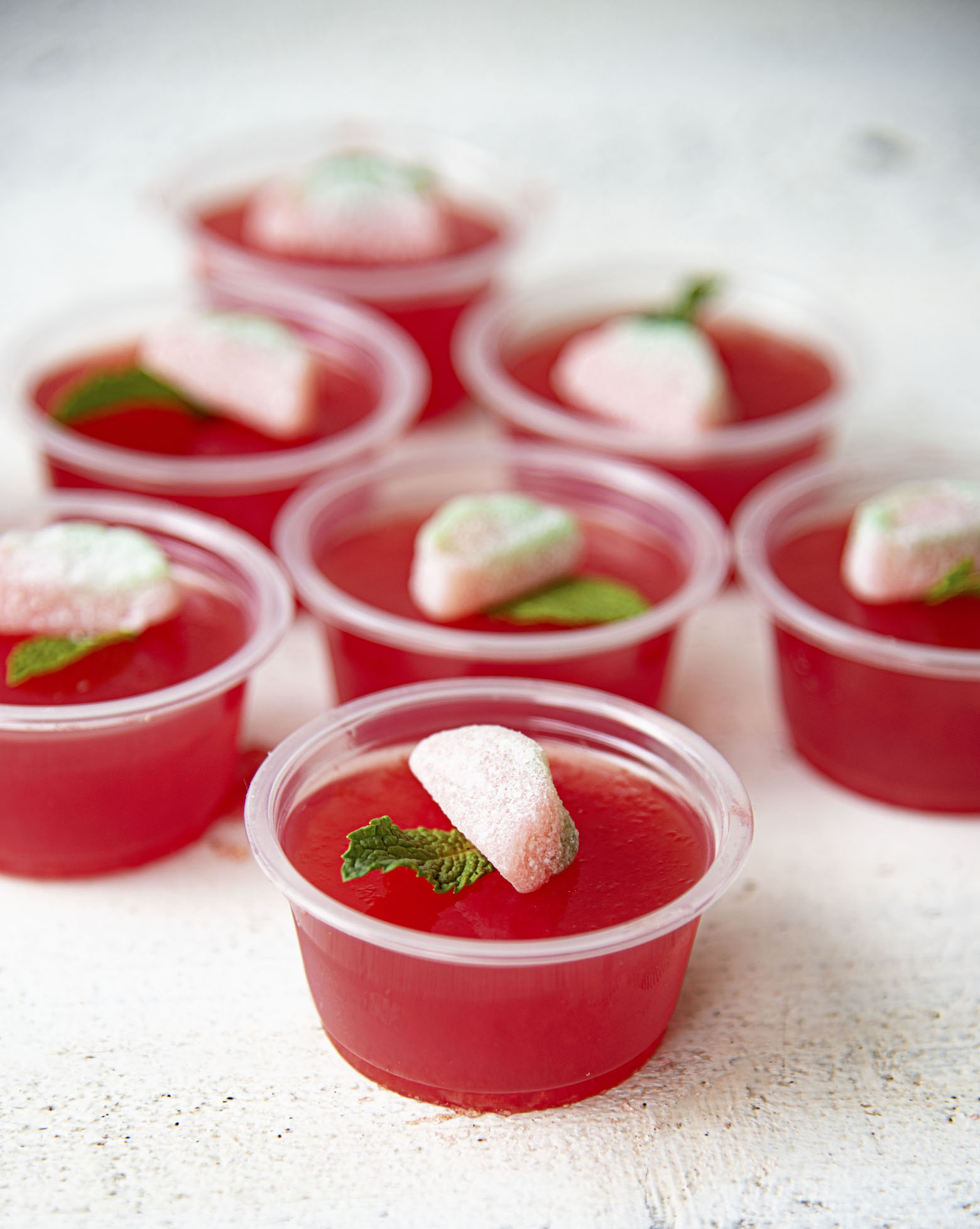 Cluster of Watermelon Mint Julep Jello Shots with first shot being in focus