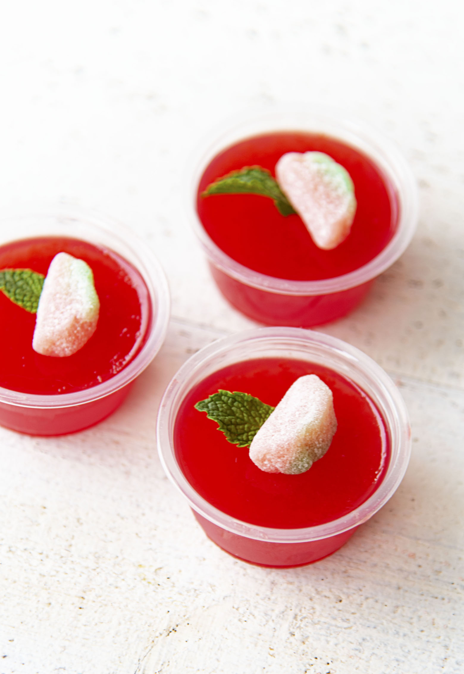 Three Watermelon Mint Julep Jello Shots together.
