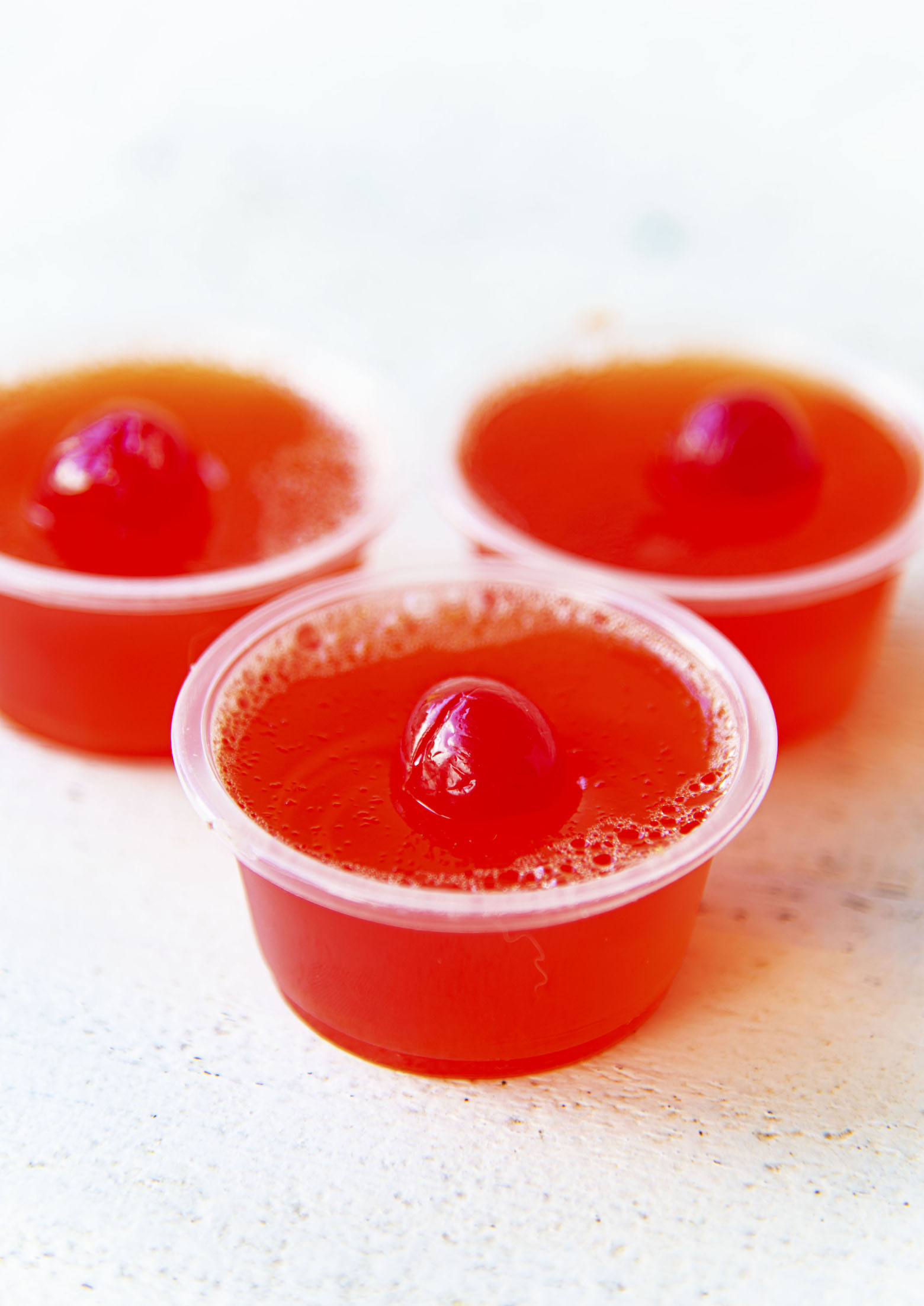 Three Hawaiian Punch Jello Shots clustered together