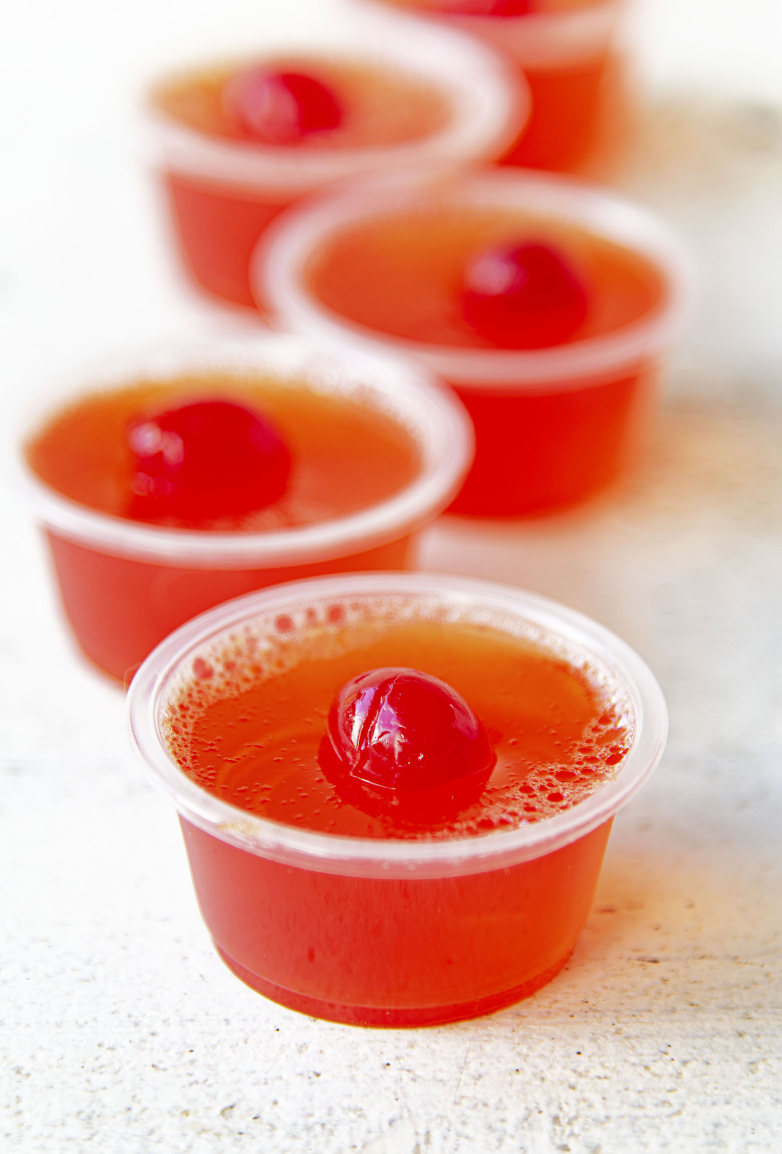 Row of  Hawaiian Punch Jello Shots with focus on first shot