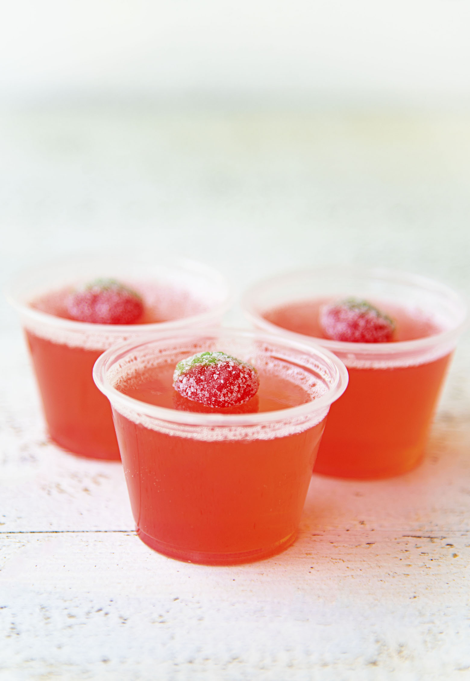 Side view of three Strawberry Lemonade Jello Shots