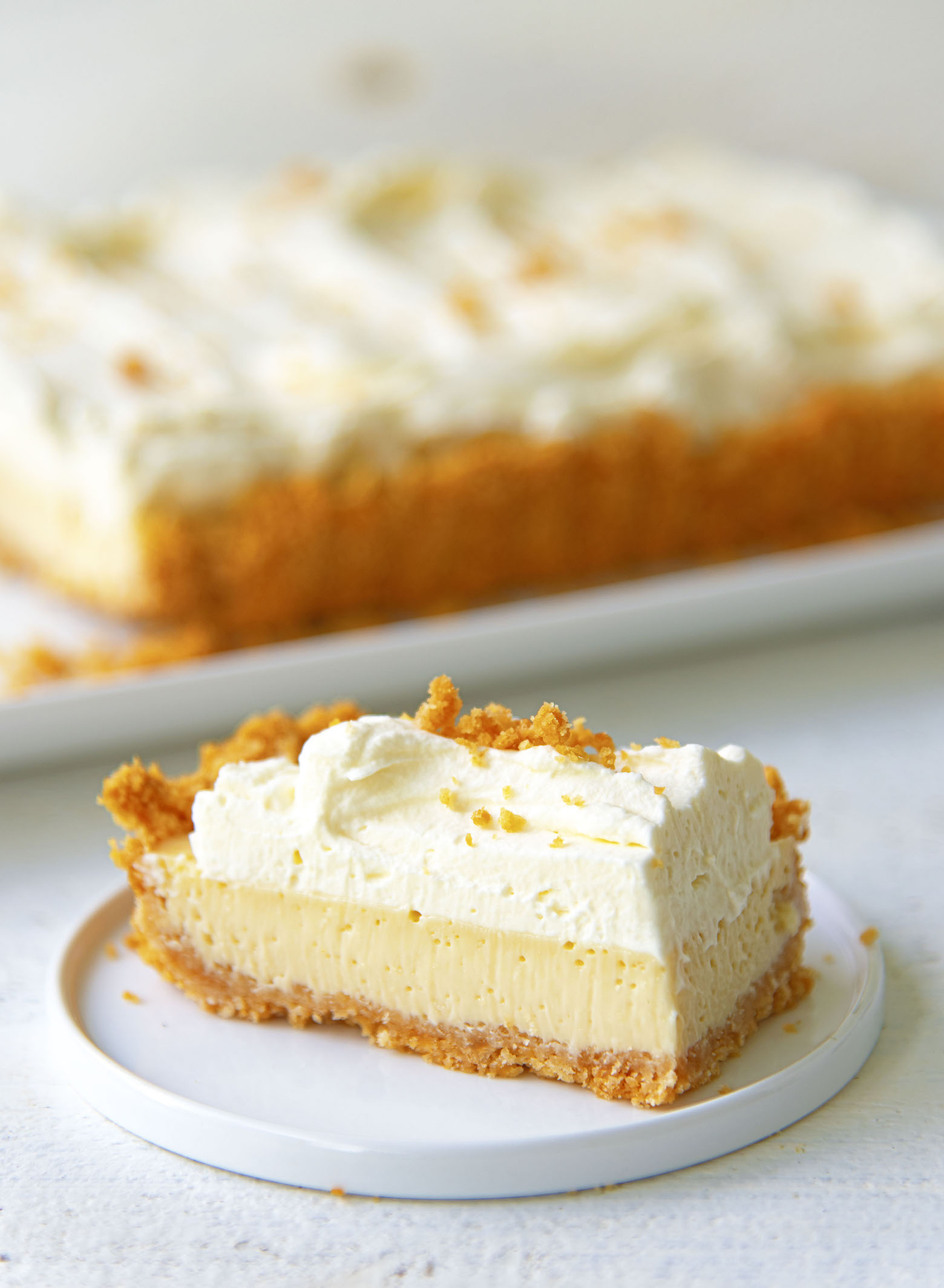 Slice of Atlantic Beach Tart on small plate with remaining tart in background .