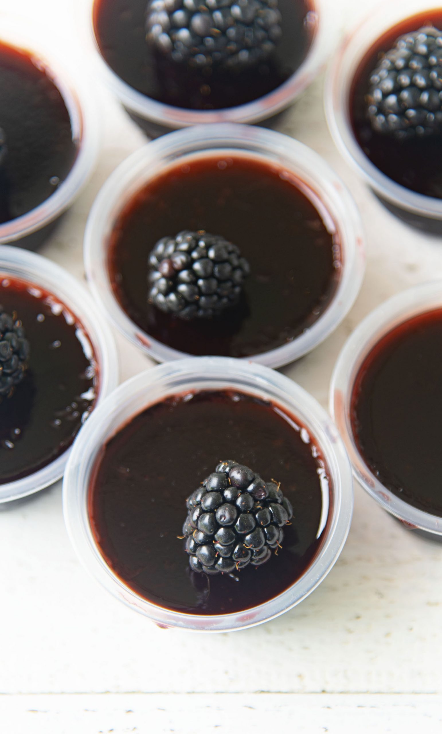 Overhead shot of several Blackberry Bourbon Jello Shots 