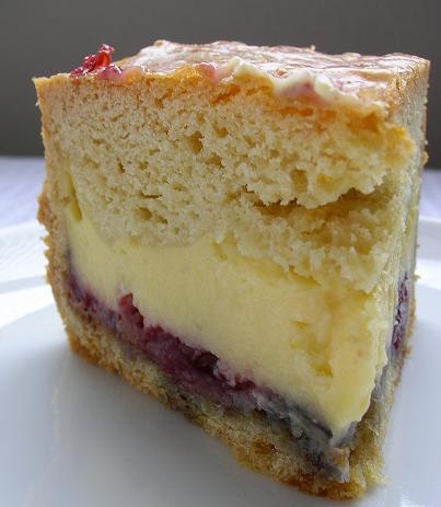 Front view of the cake with the layers of pastry cream and jam exposed. 