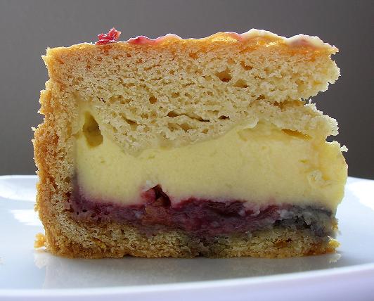 Side view of Basque Cake with pastry cream and jam exposed.