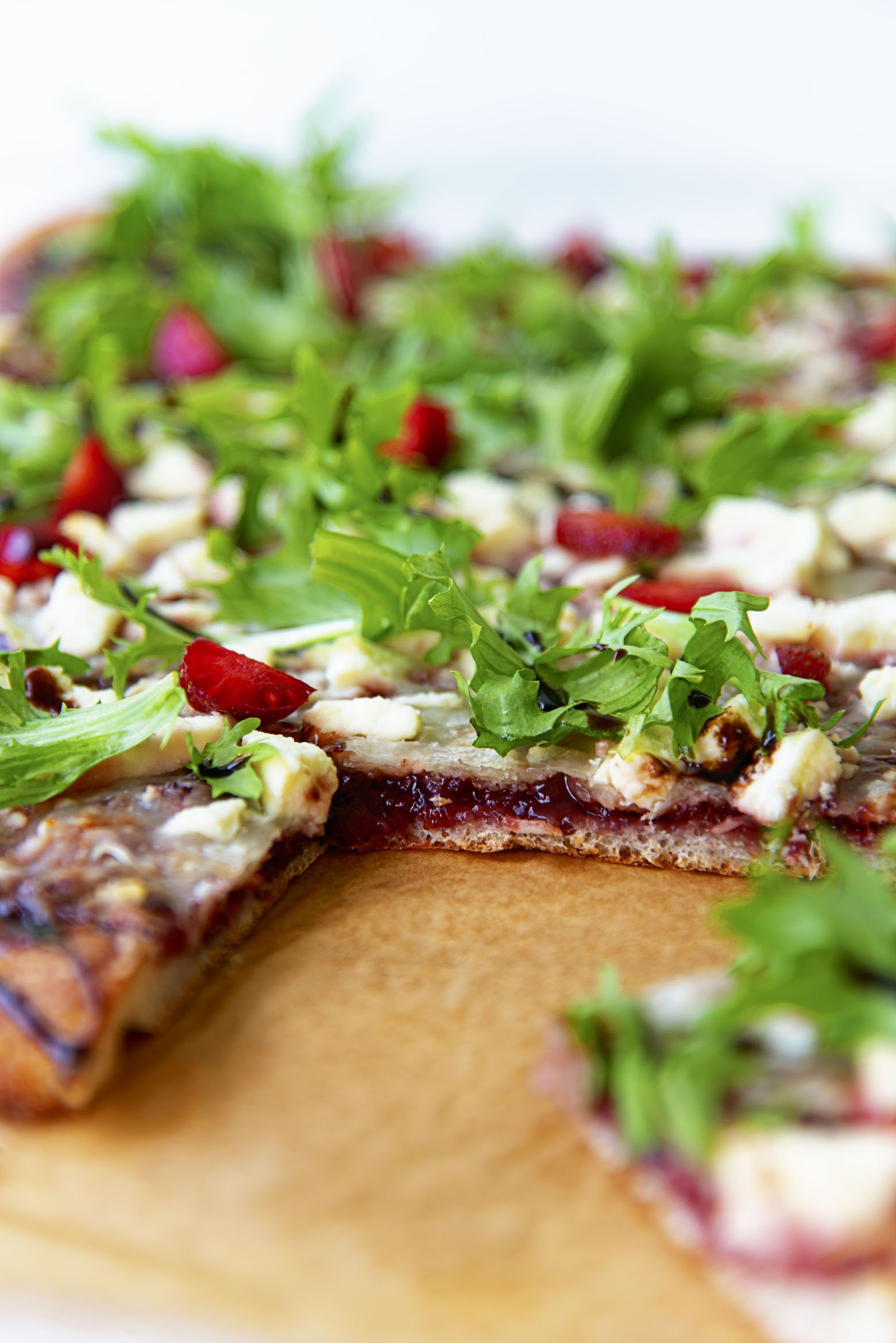 Close up of cut flatbread with jam exposed