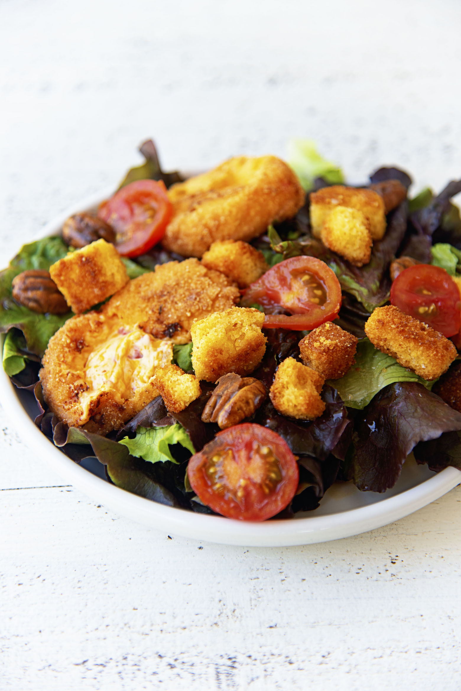 Picture of the salad with the fried cheese pulled open.