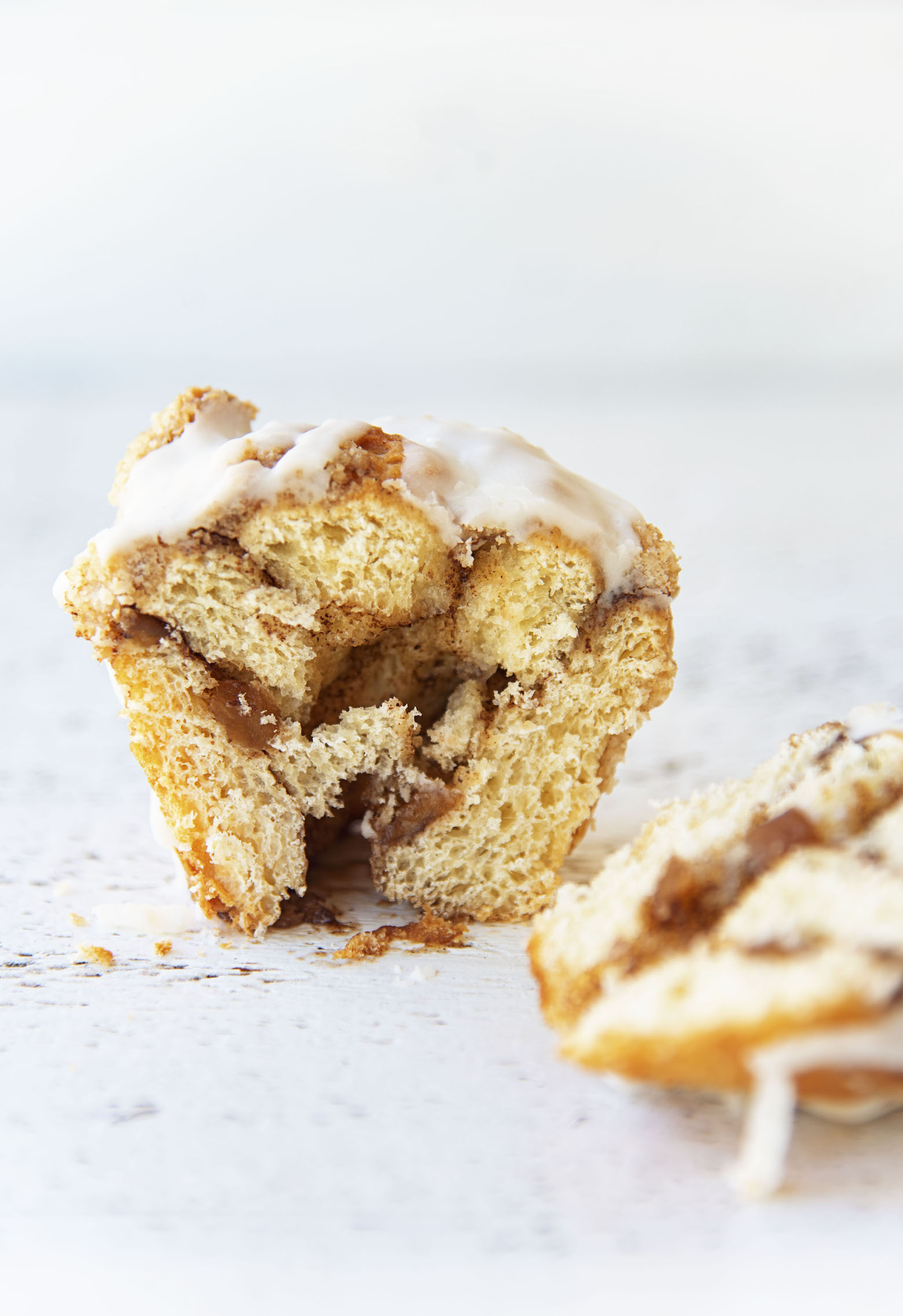 Single Apple Crumb Cinnamon Roll cut in half to expose center.